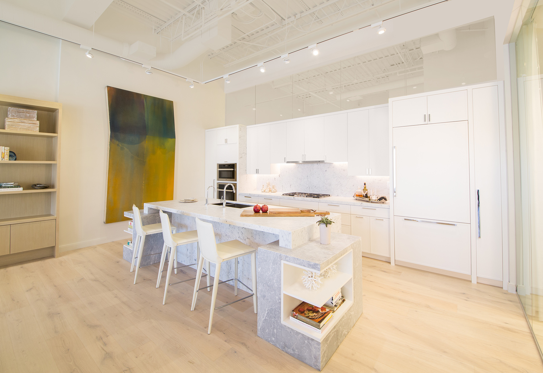 Inside the 3550 South Ocean sales gallery in Palm Beach, showing a bright and modern open kitchen.