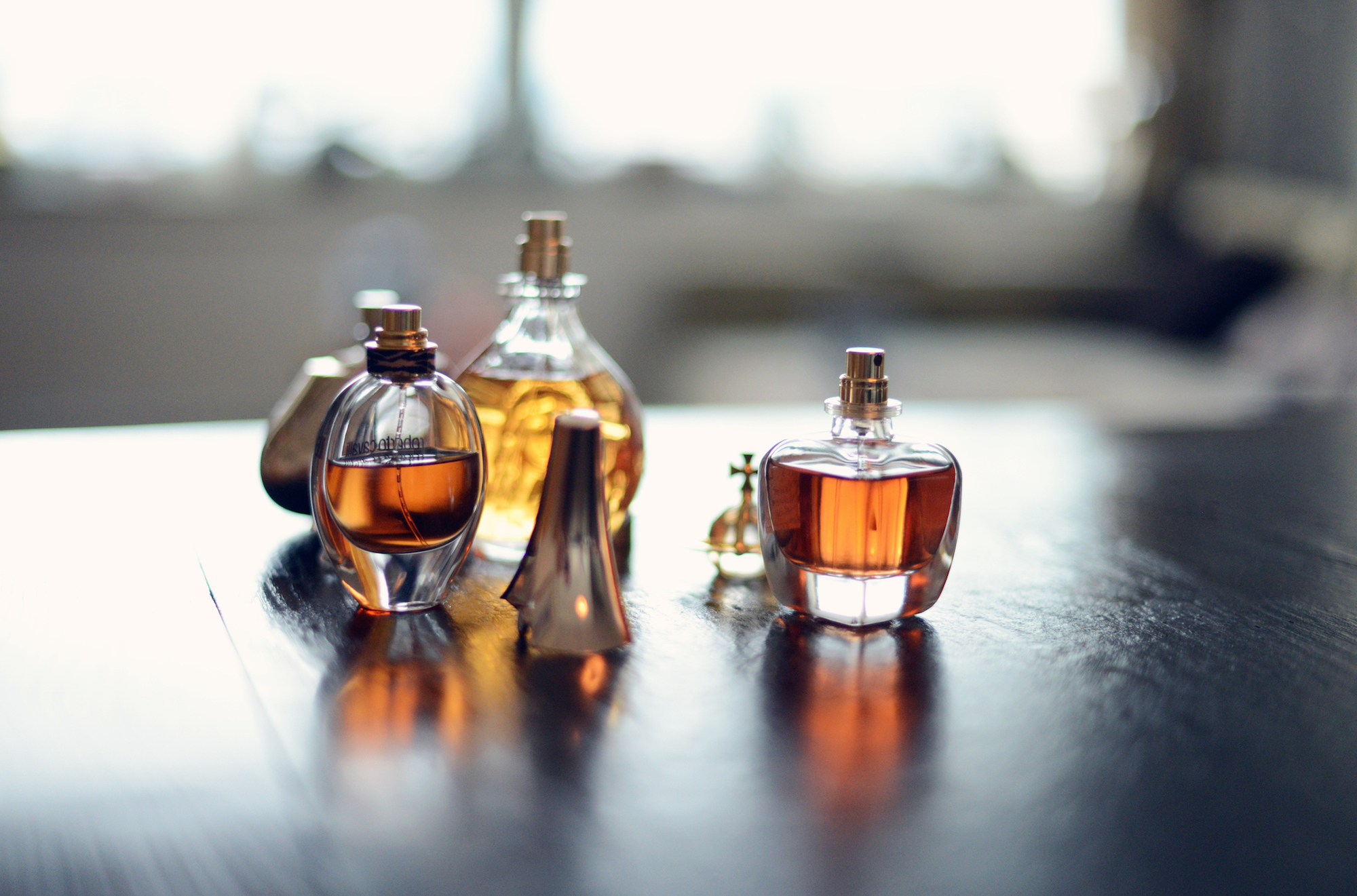 Four amber perfume bottles on a table
