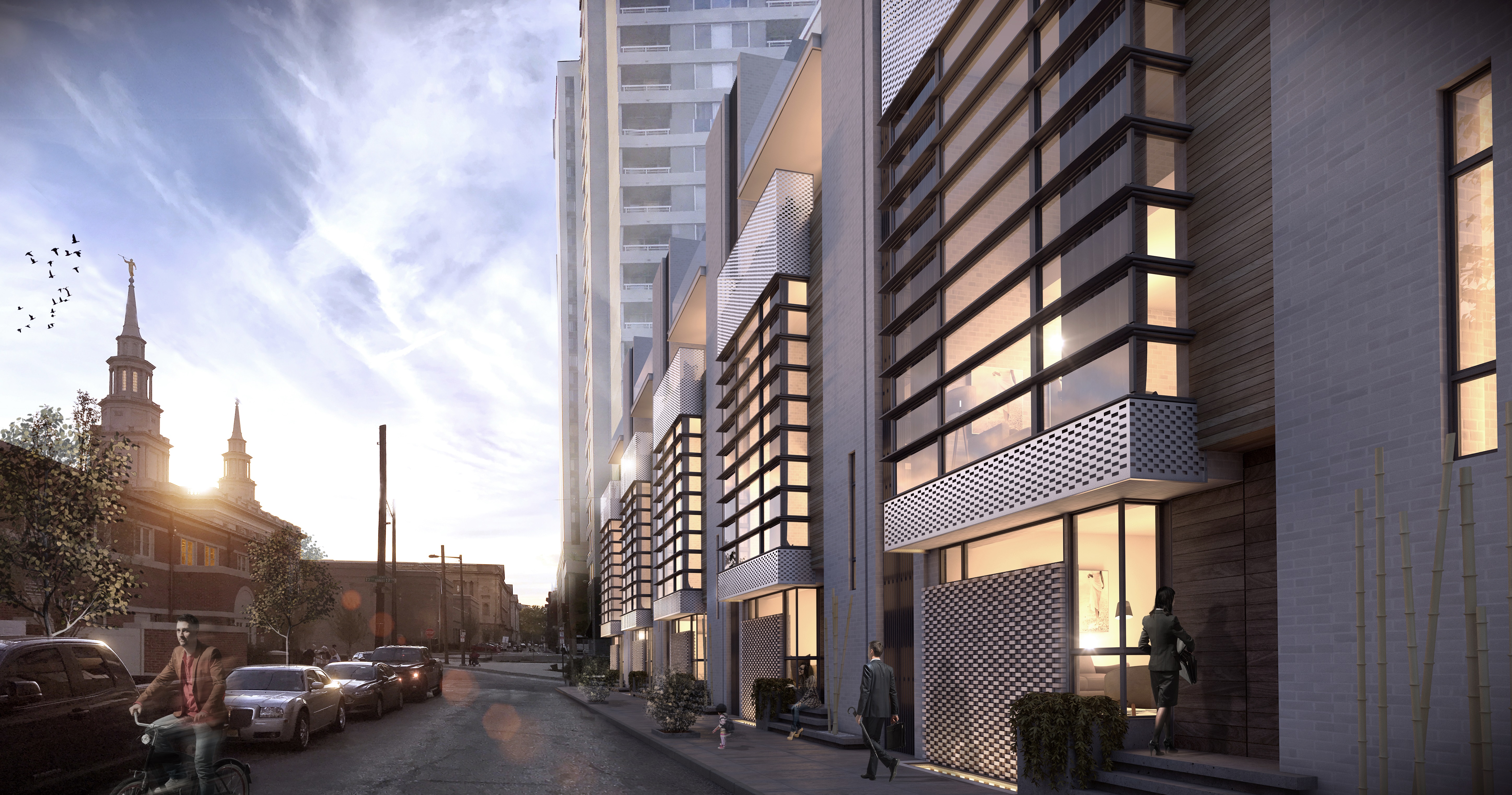 A rendering of a series of contemporary townhomes lit up at night.