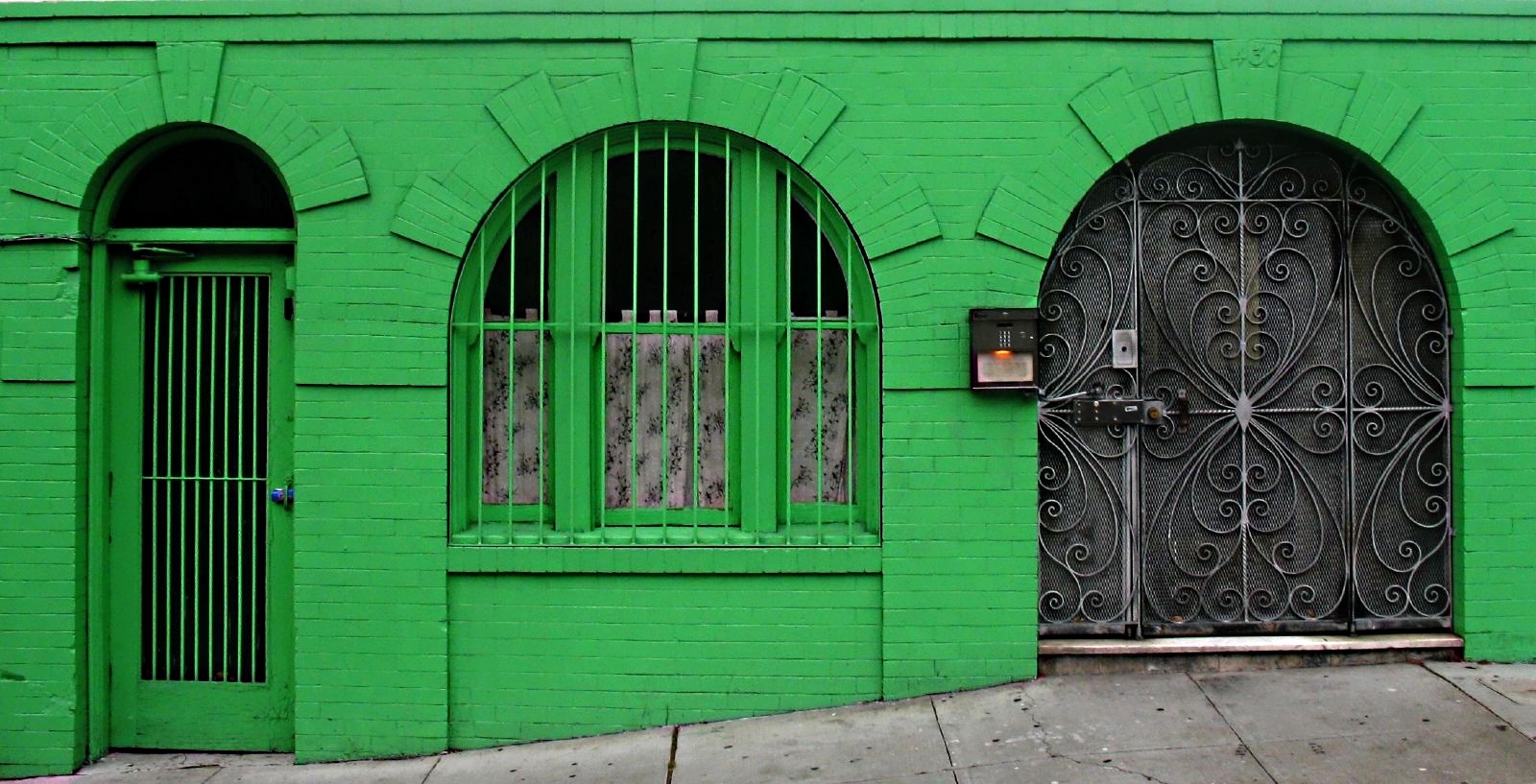 Green facade of apartment building.