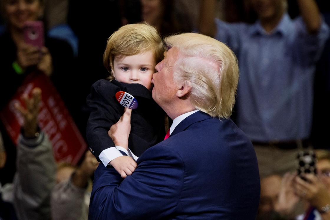 Trump kissing a small child, poor kid