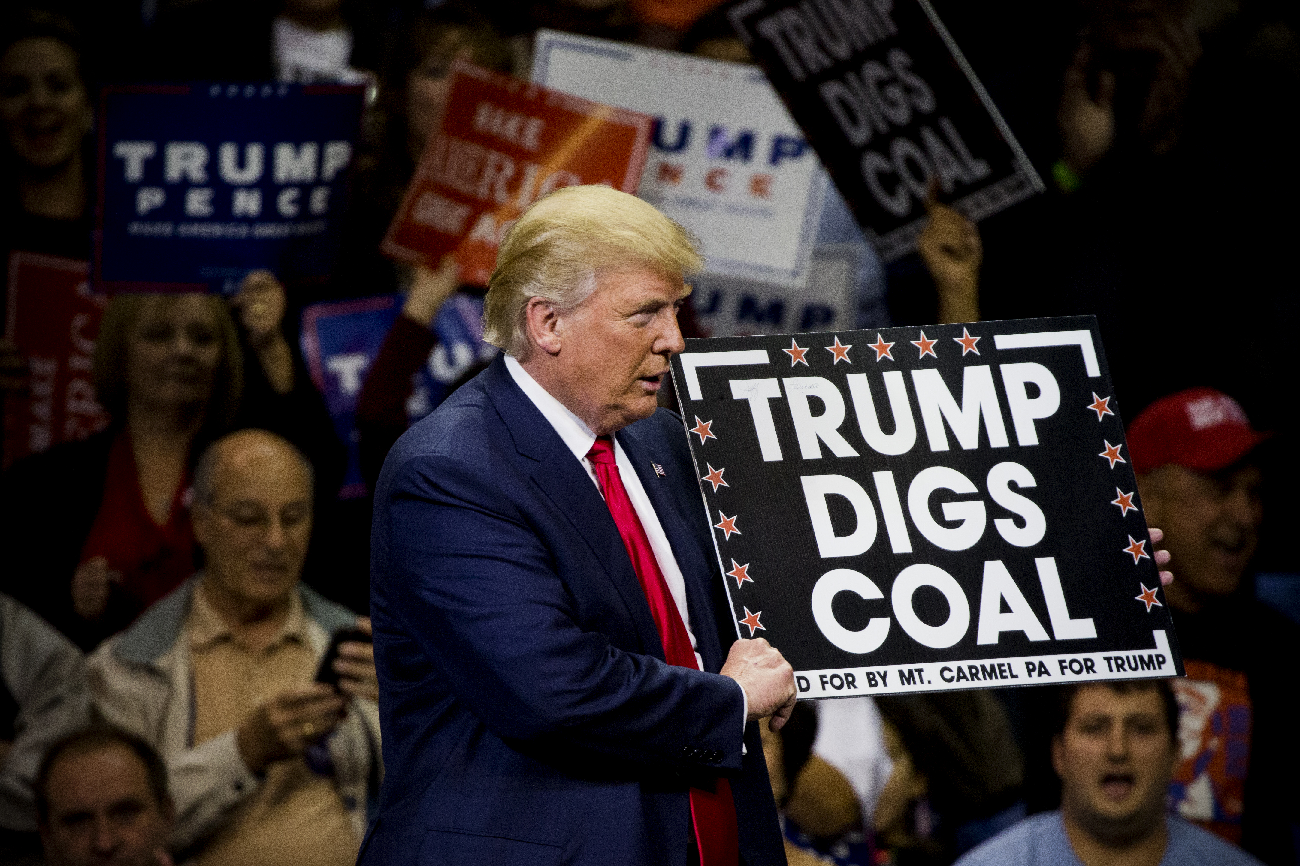 Donald Trump&nbsp;holds a sign supporting coal during a presidential campaign rally in Wilkes-Barre, Pennsylvania on October 10, 2016.