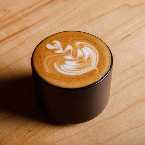 Close-up of an espresso drink with artsty foam.