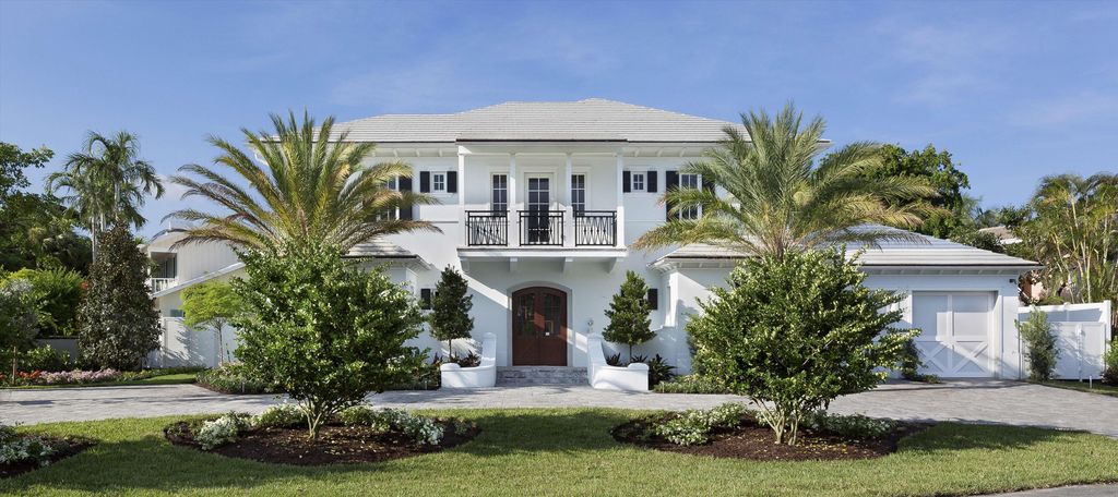 A white home in Delray Beach with nicely manicured grounds