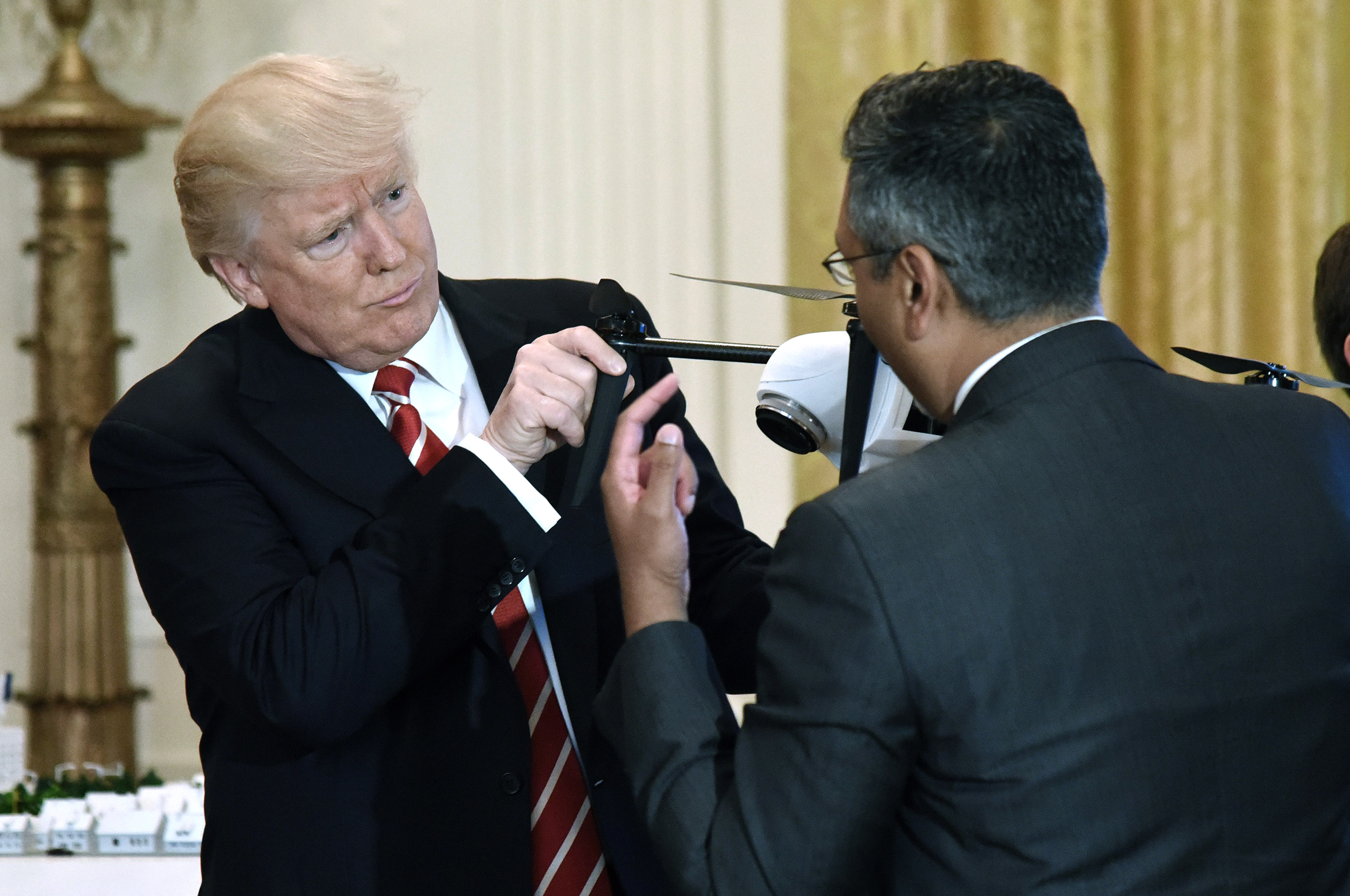 President Donald Trump inspects a drone at the White House.