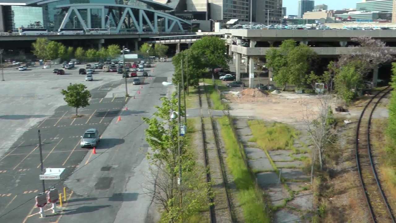 A view of the gulch, a large parking lot, and rail lines.