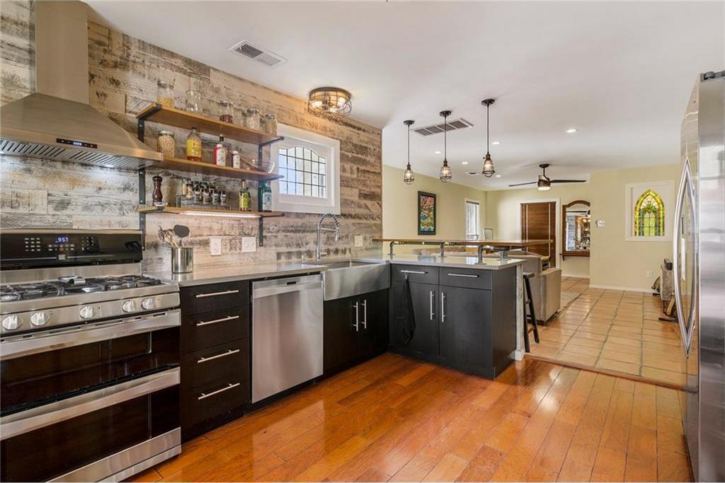 Open kitchen/living area with partial brick wall