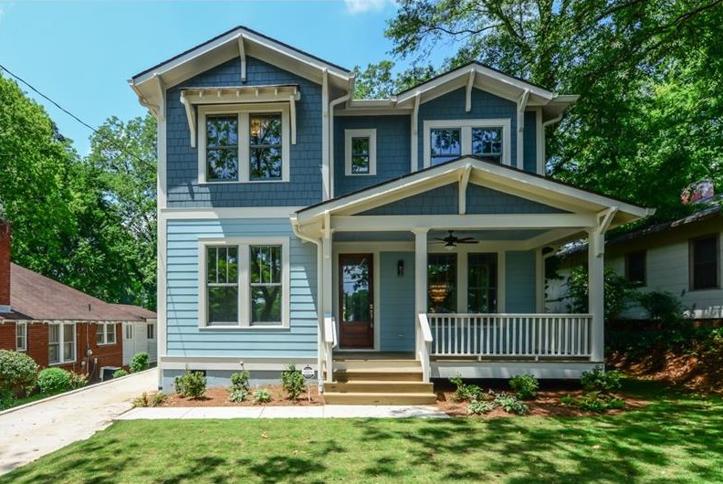 Two-story blue house with covered front porch.
