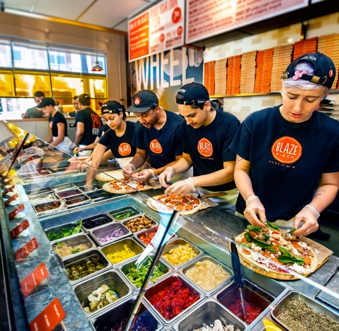Employees at a Blaze Pizza location