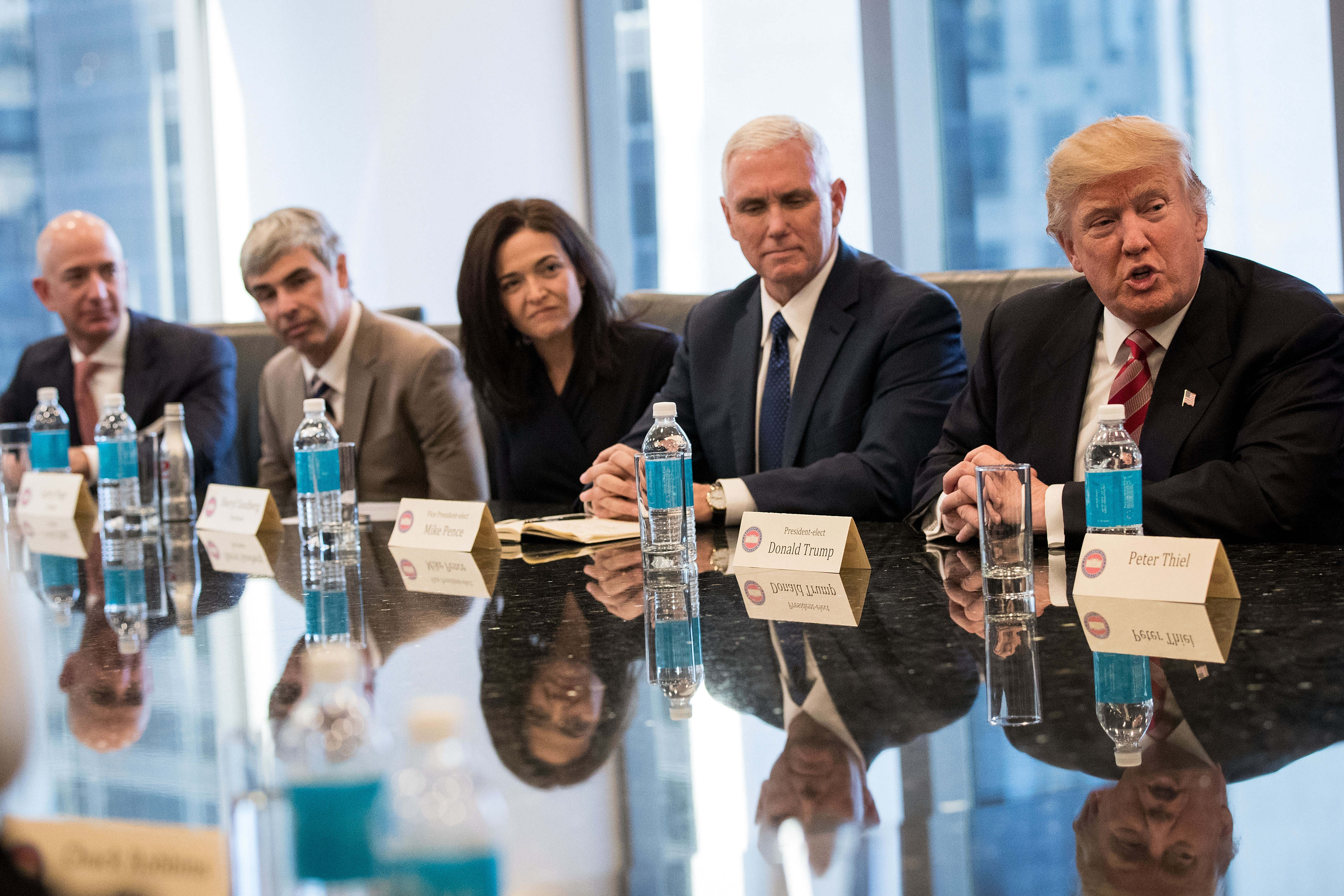 Amazon CEO Jeff Bezos, Google’s Larry Page, Facebook CFO Sheryl Sandberg, VP Mike Pence and President Donald Trump sitting at a table