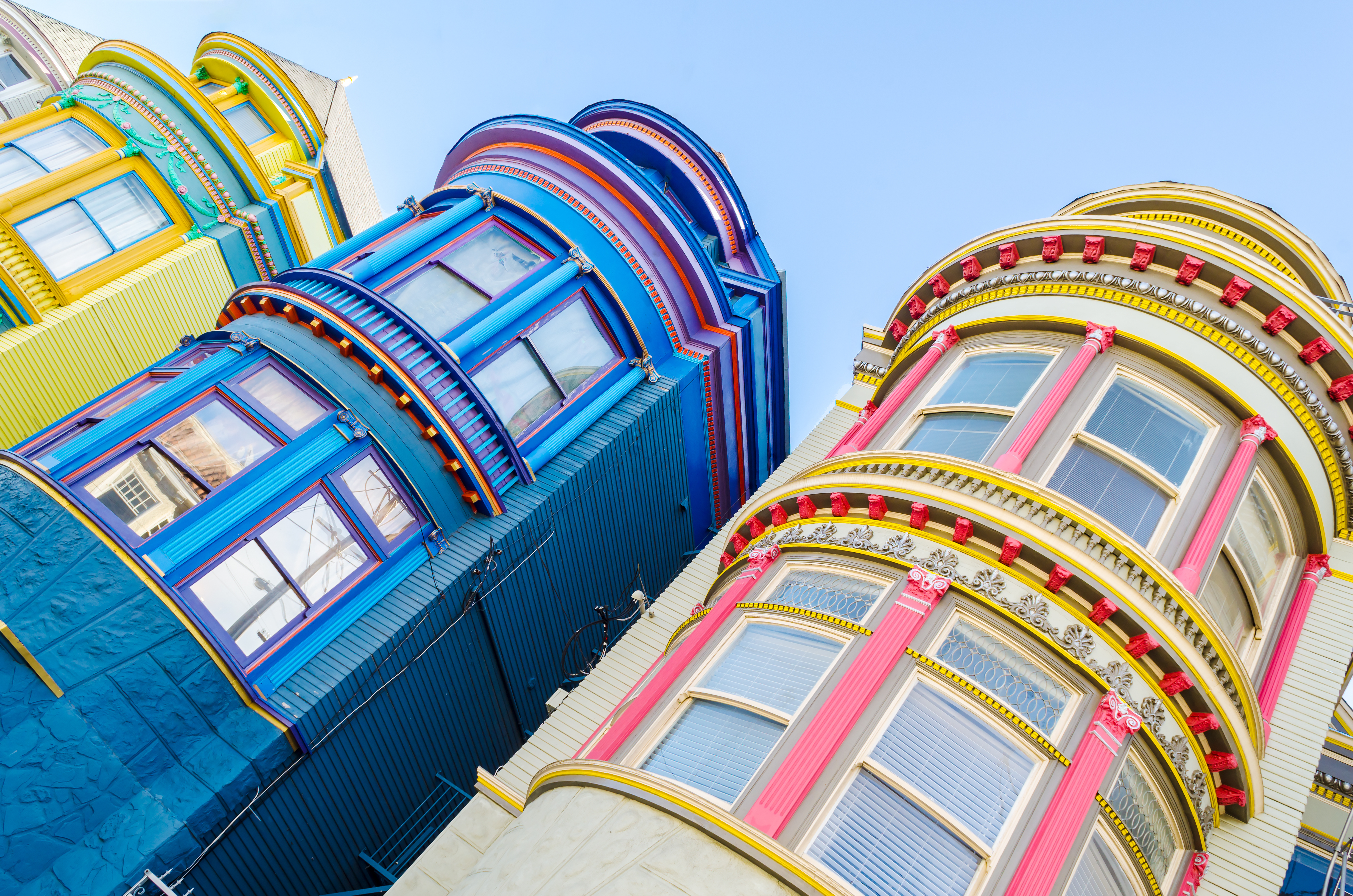 A Dutch angle shot of colorful houses in San Francisco.