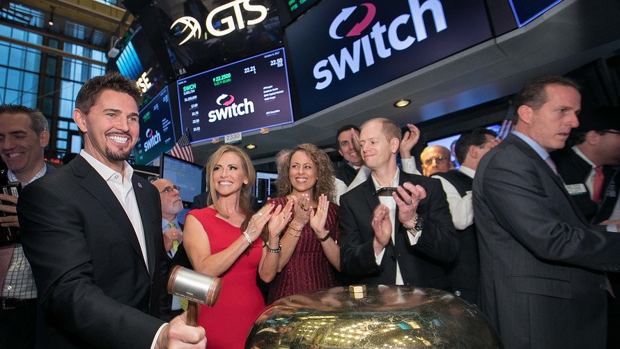 Rob Roy, founder and chief executive of Switch Inc., rings the bell to start trading Friday morning on the New York Stock Exchange.