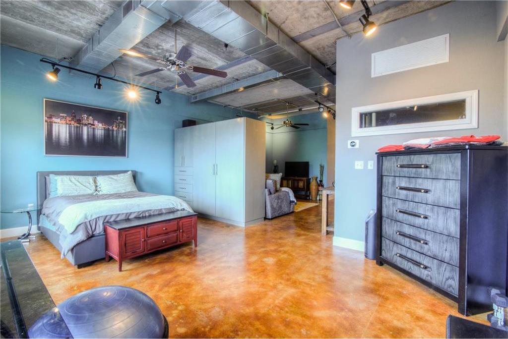 Loft living room with blue walls and concrete floors