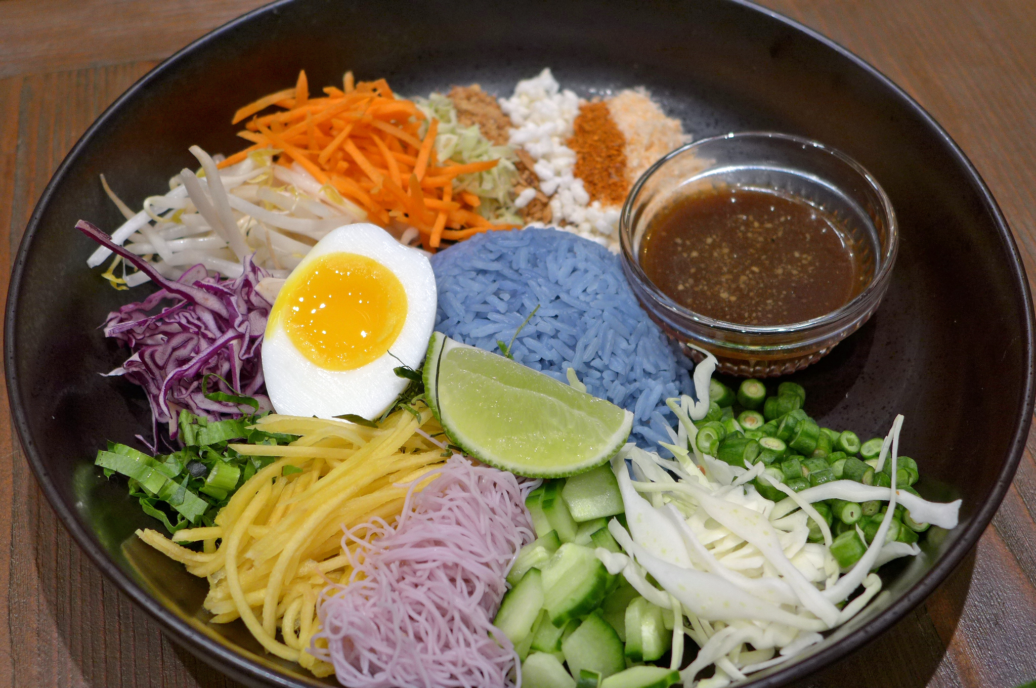 A bowl filled with all sorts of colorful ingredients.
