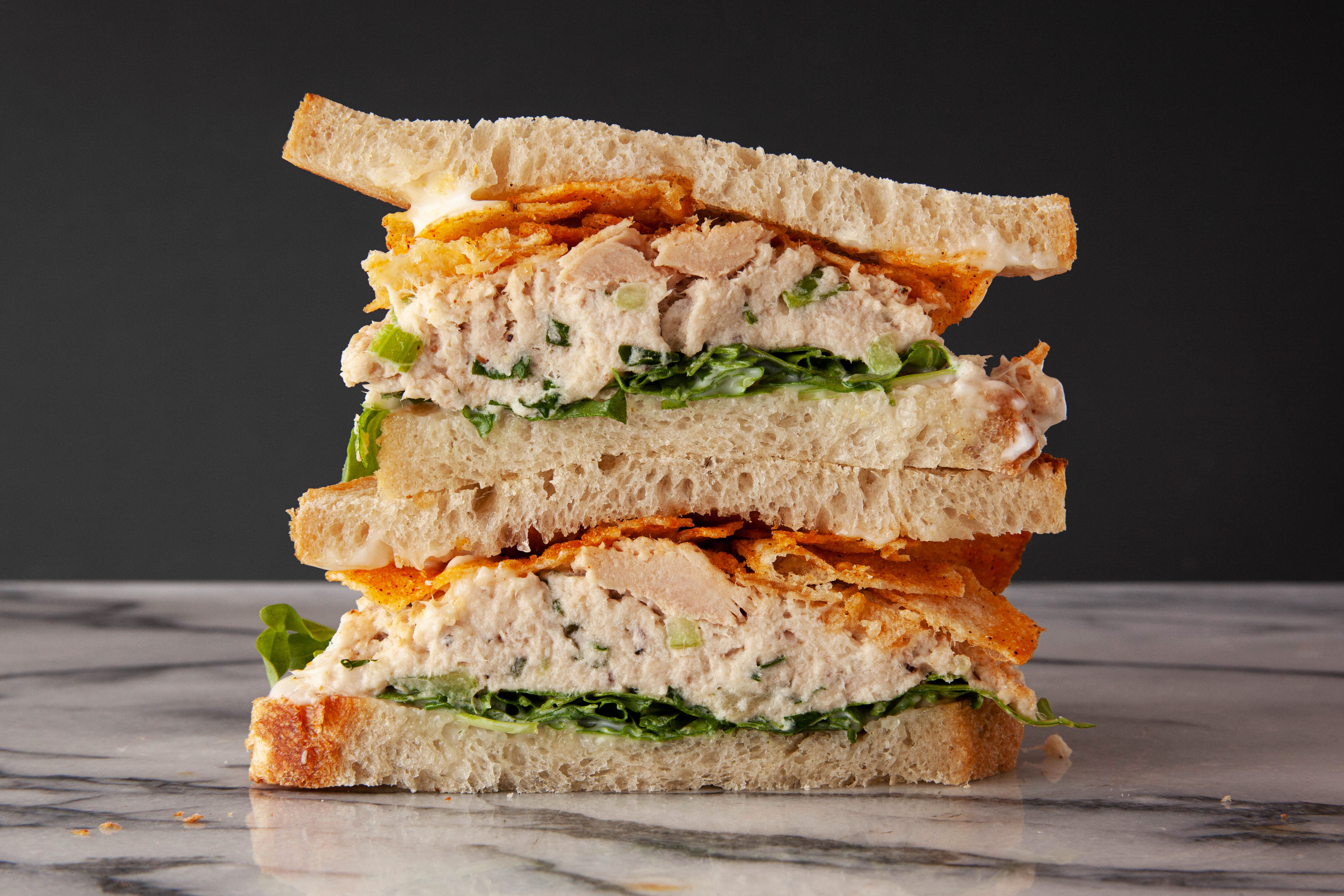 Two halves of a tuna sandwich stacked on top of each other.