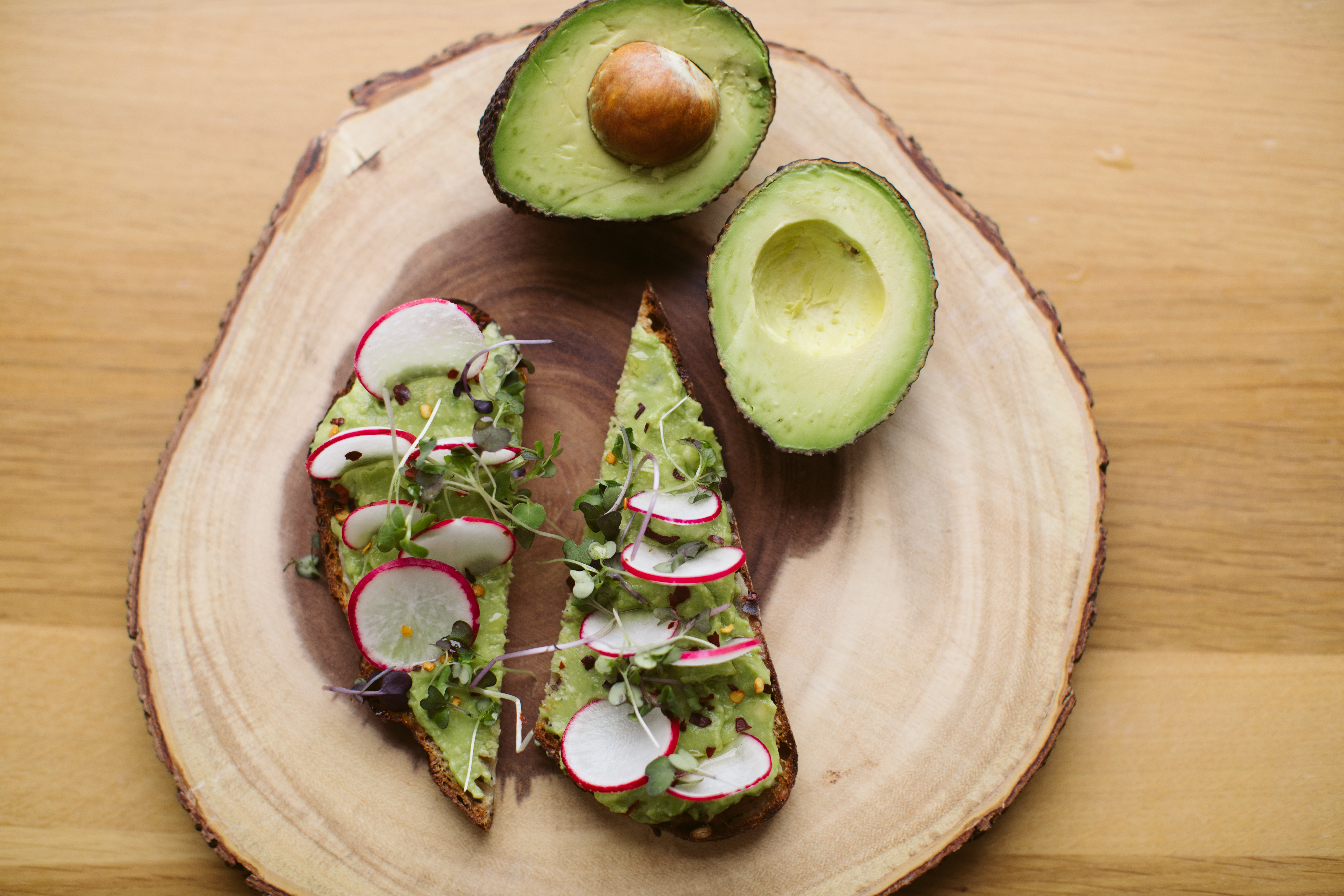 Avocado toast topped with radishes and microgreens