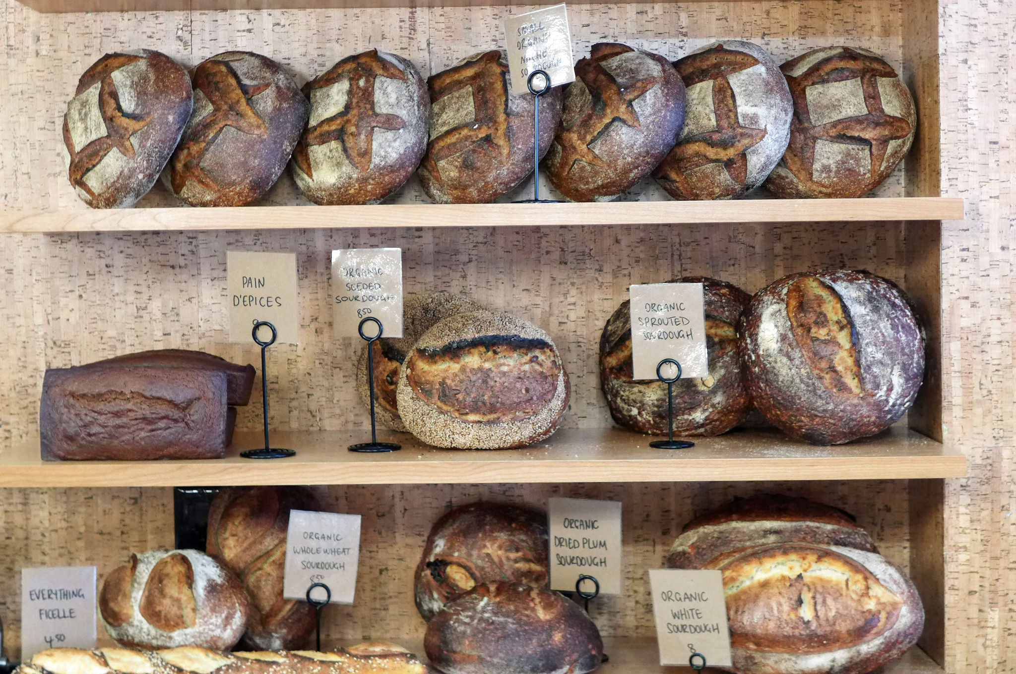 Breads on shelves at Bourke Street Bakery.
