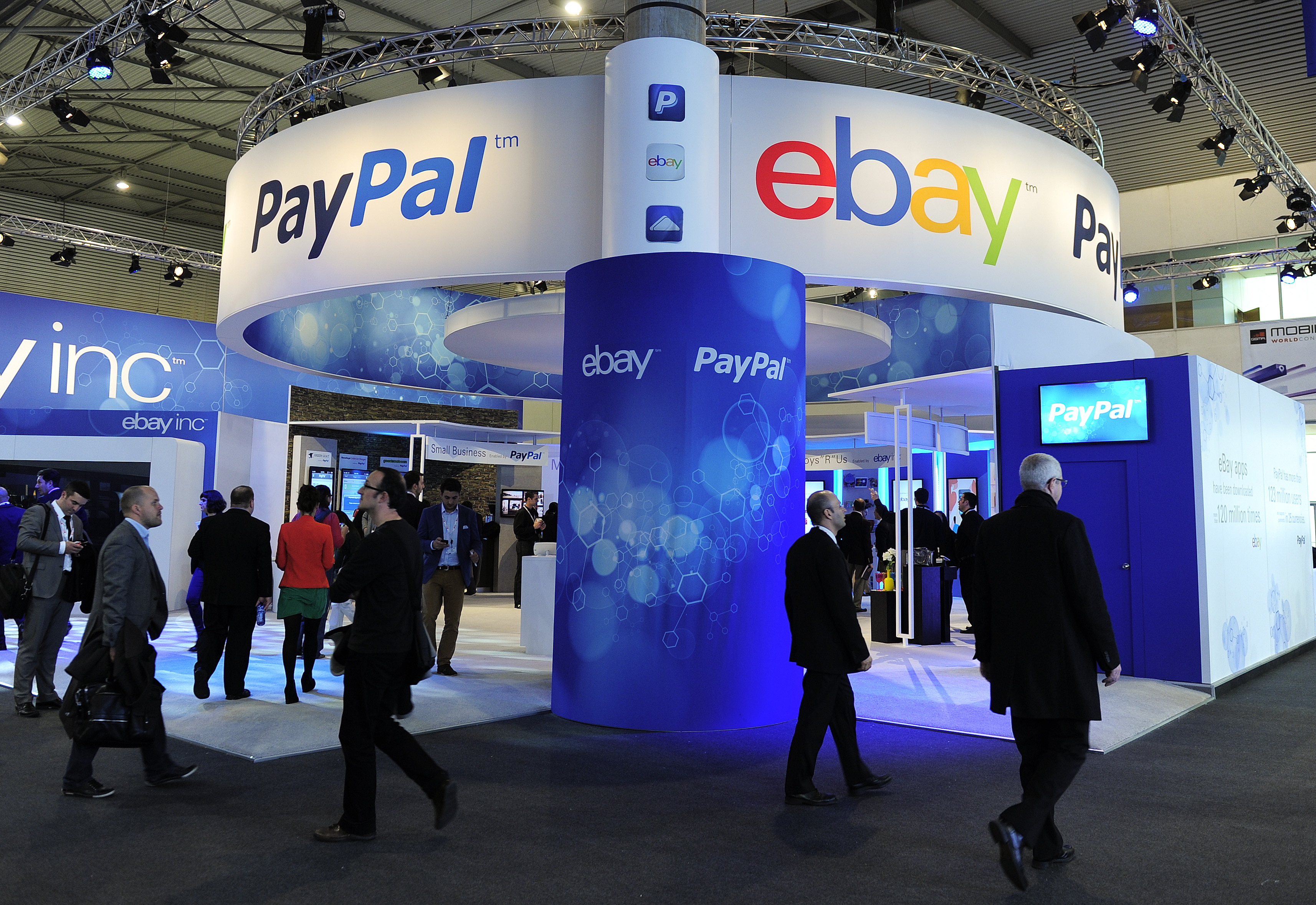 Visitors walk past an Ebay and PayPal stand at the 2013 Mobile World Congress in Barcelona on February 27, 2013.&nbsp;