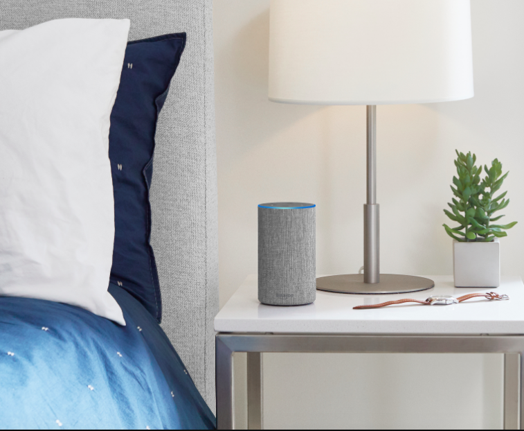 The new $100 Amazon Echo in grey, on a nightstand