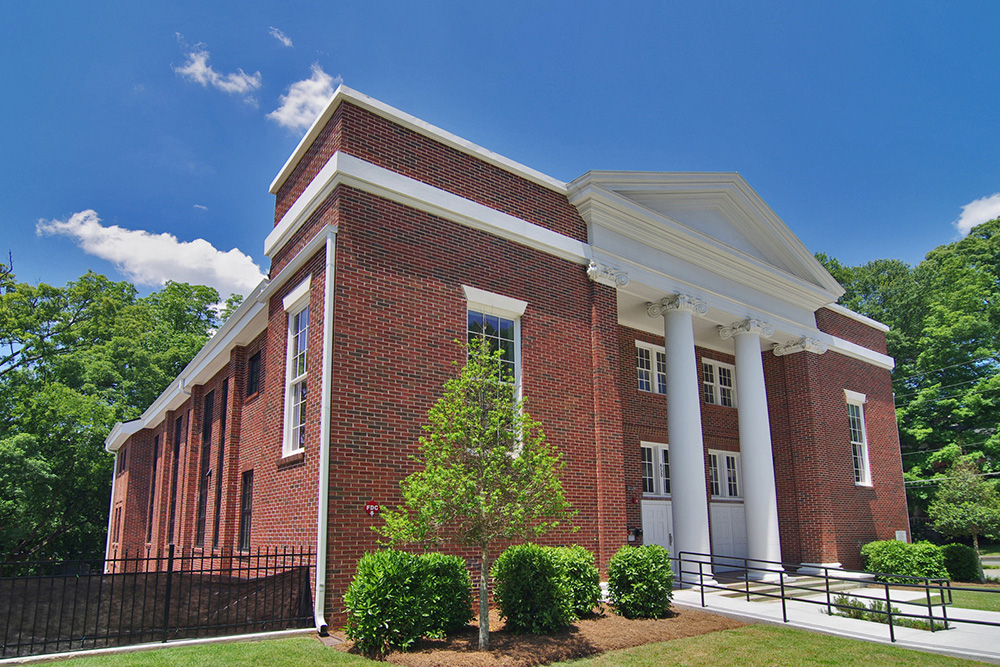 A two-story classical red brick church.