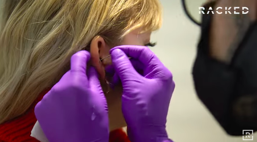 Rebecca Jennings getting her ear pierced