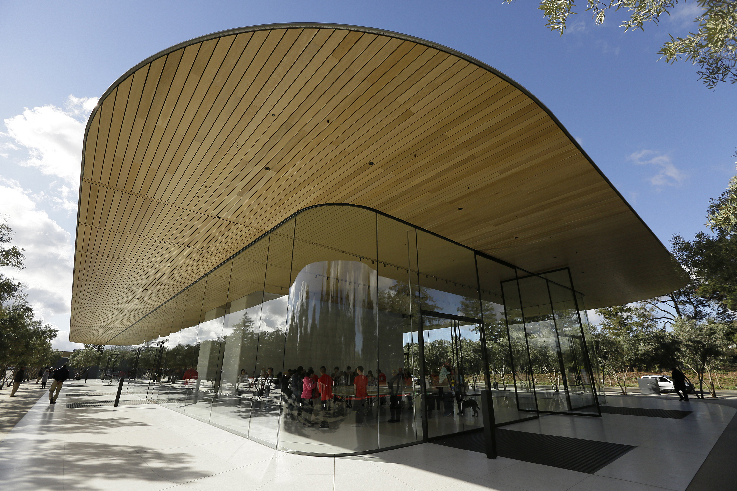 Shown is an exterior view of the Apple Park Visitor Center during its grand opening Friday, Nov. 17, 2017, in Cupertino, Calif. (AP Photo/Eric Risberg)
