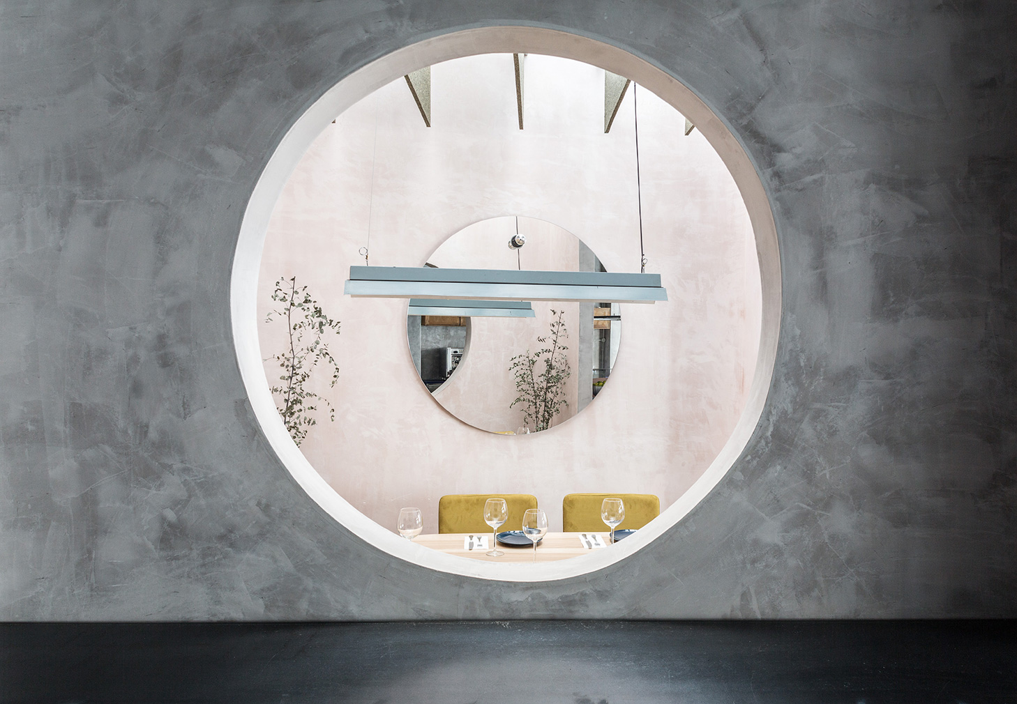 Seville restaurant with concrete, pastels, circles