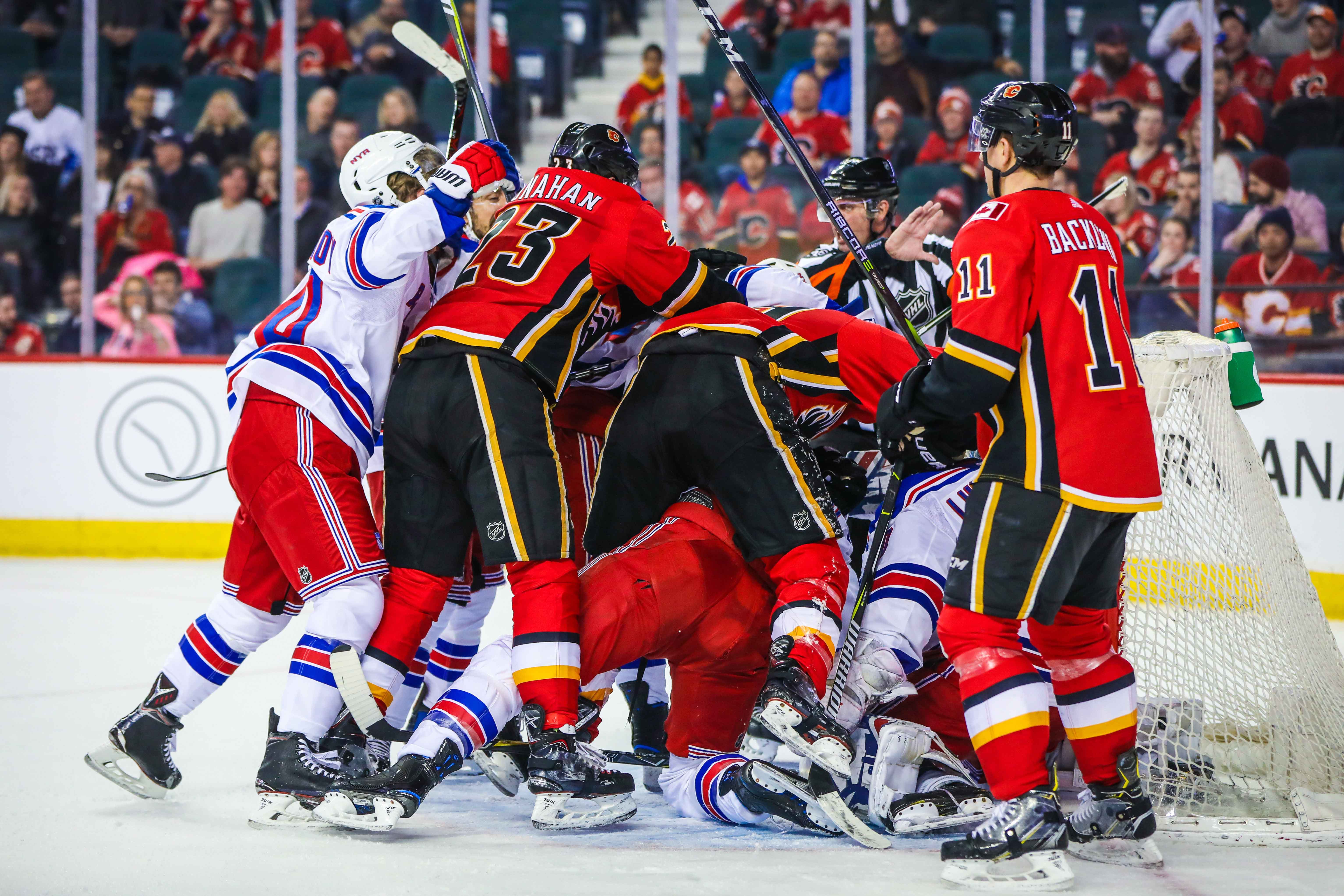 Mar 2, 2018; Calgary, Alberta, CAN; Calgary Flames players fight with New York Rangers players in front of New York Rangers goaltender Henrik Lundqvist (30) net during the third period at Scotiabank Saddledome. New York Rangers won 3-1.