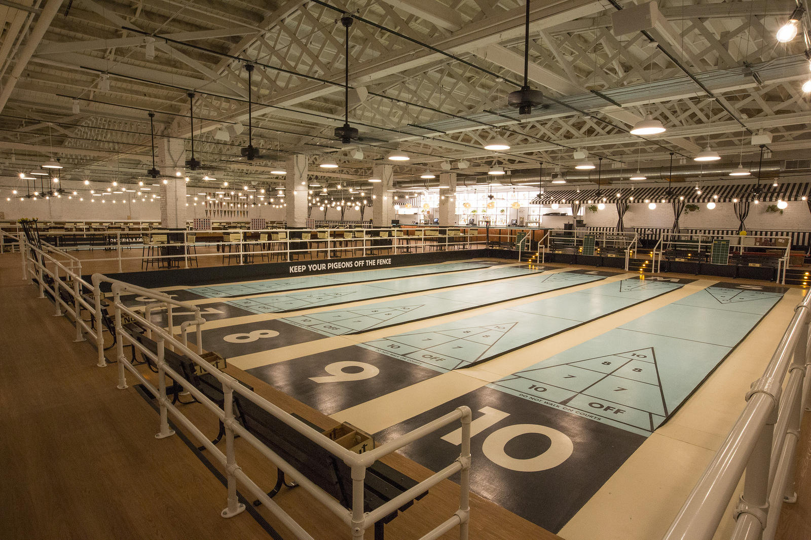 A glorious shuffleboard club with vacant lanes.