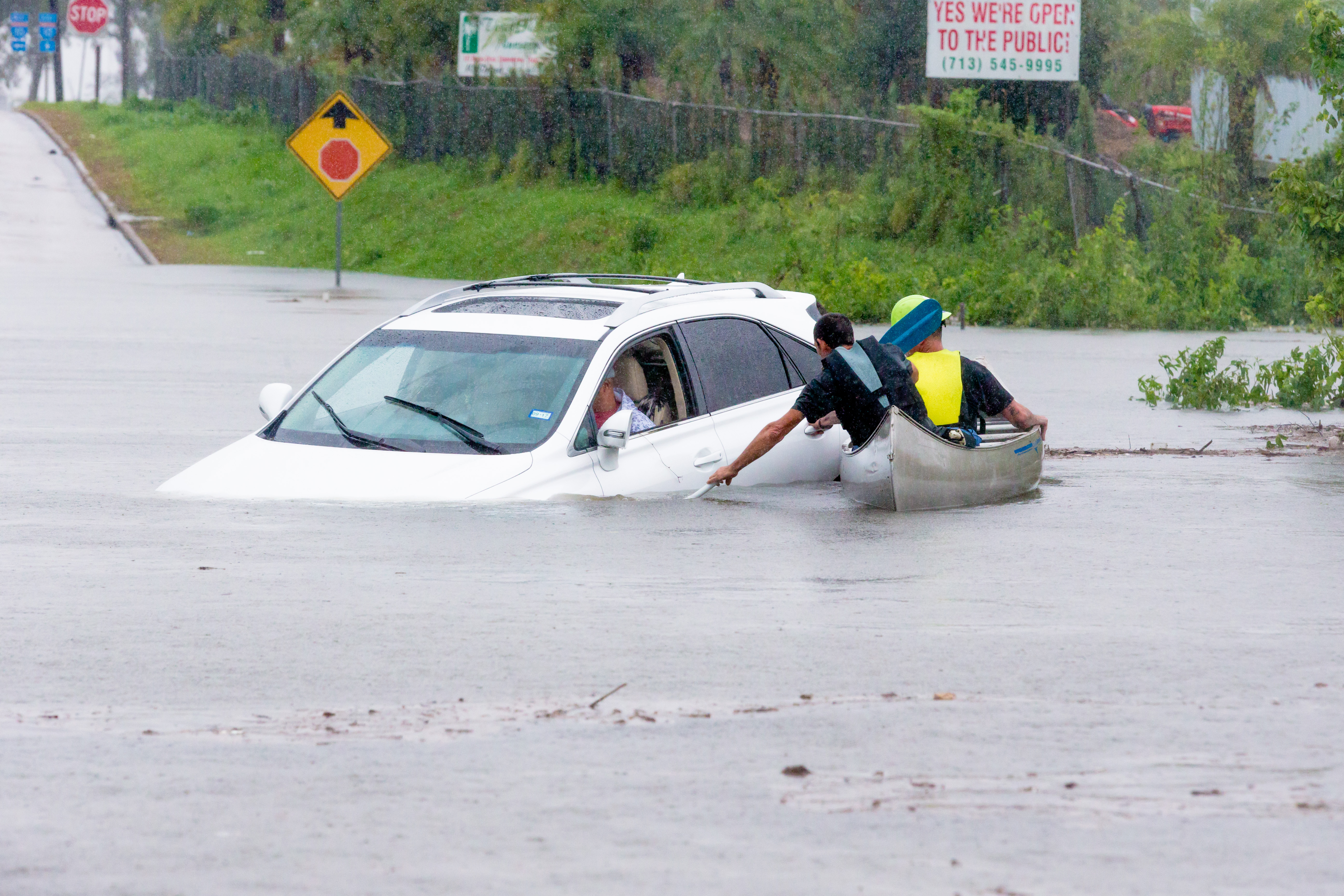 HOUSTON, TX - AUGUST 29: Volunteers in a canoe makes their way to assist a driver that was stalled going through high water during Hurricane Harvey, Monday, August 29, 2017. 