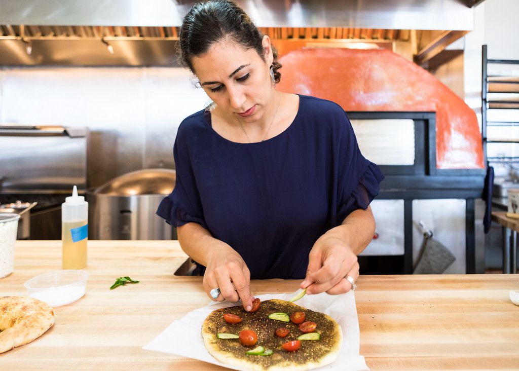 Reem Assil prepares a flatbread at bakery Reem’s California