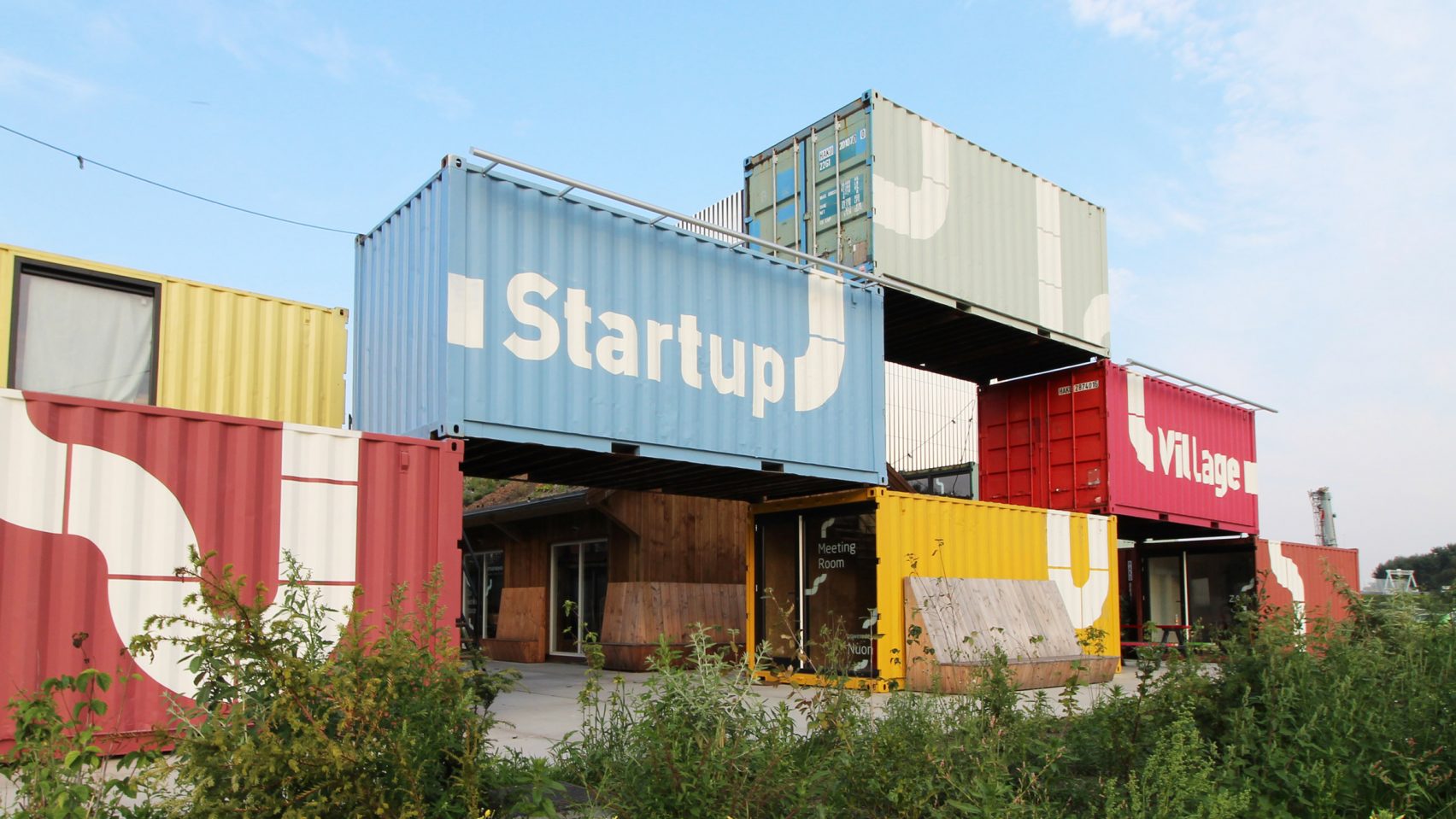 Stacked shipping containers form a building.