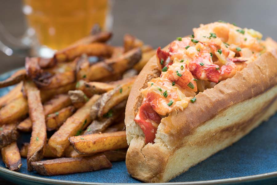A plate of lobster roll and fries.