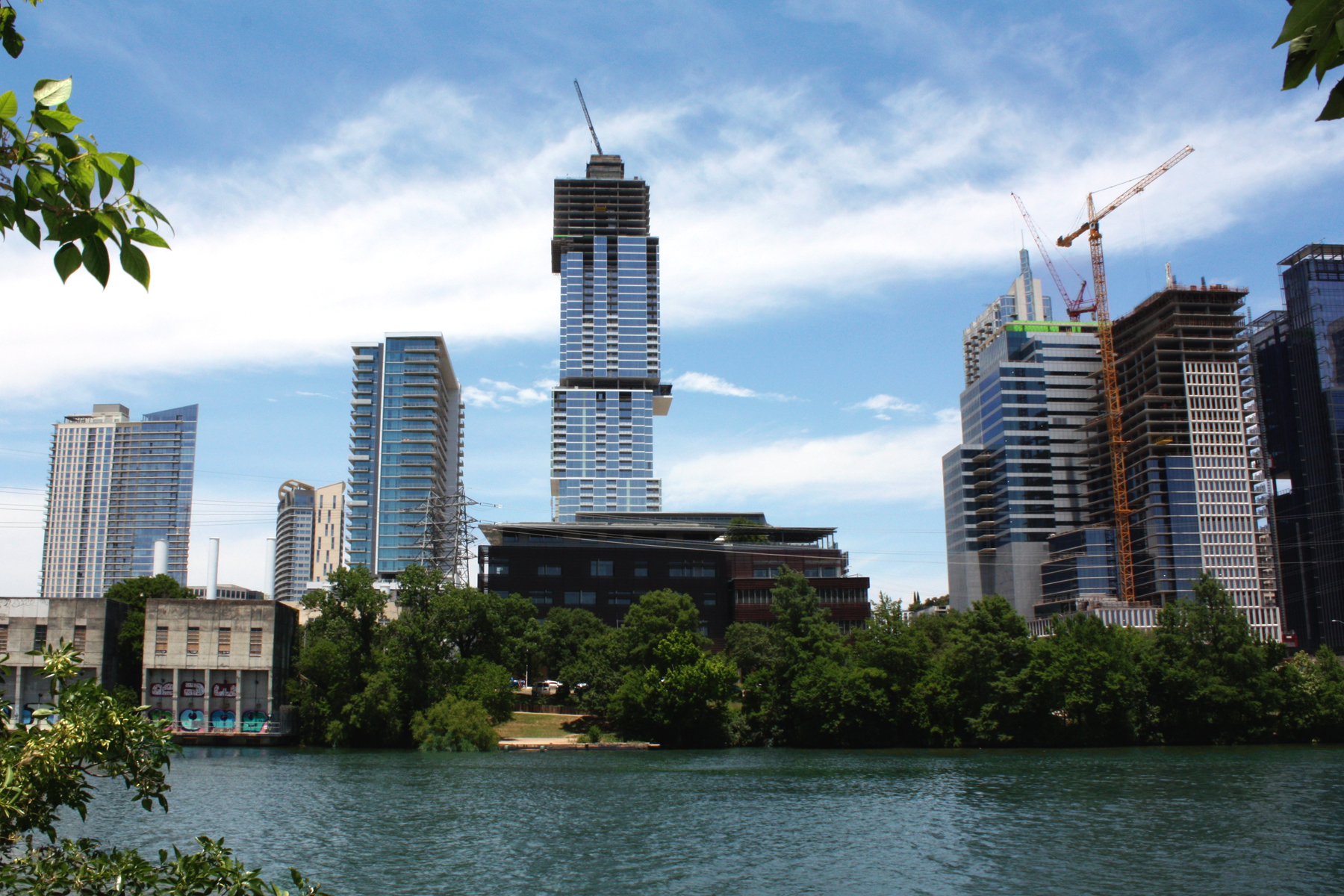 Medium shot of a skyline with tallest building, still under construction, standing out