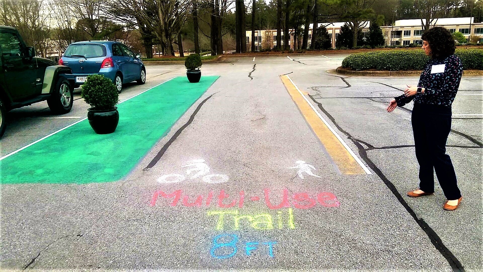 A photo of chalk drawings of bike and pedestrian lanes.