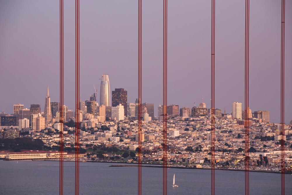 The SF skyline seen through the cables of the Golden Gate Bridge.