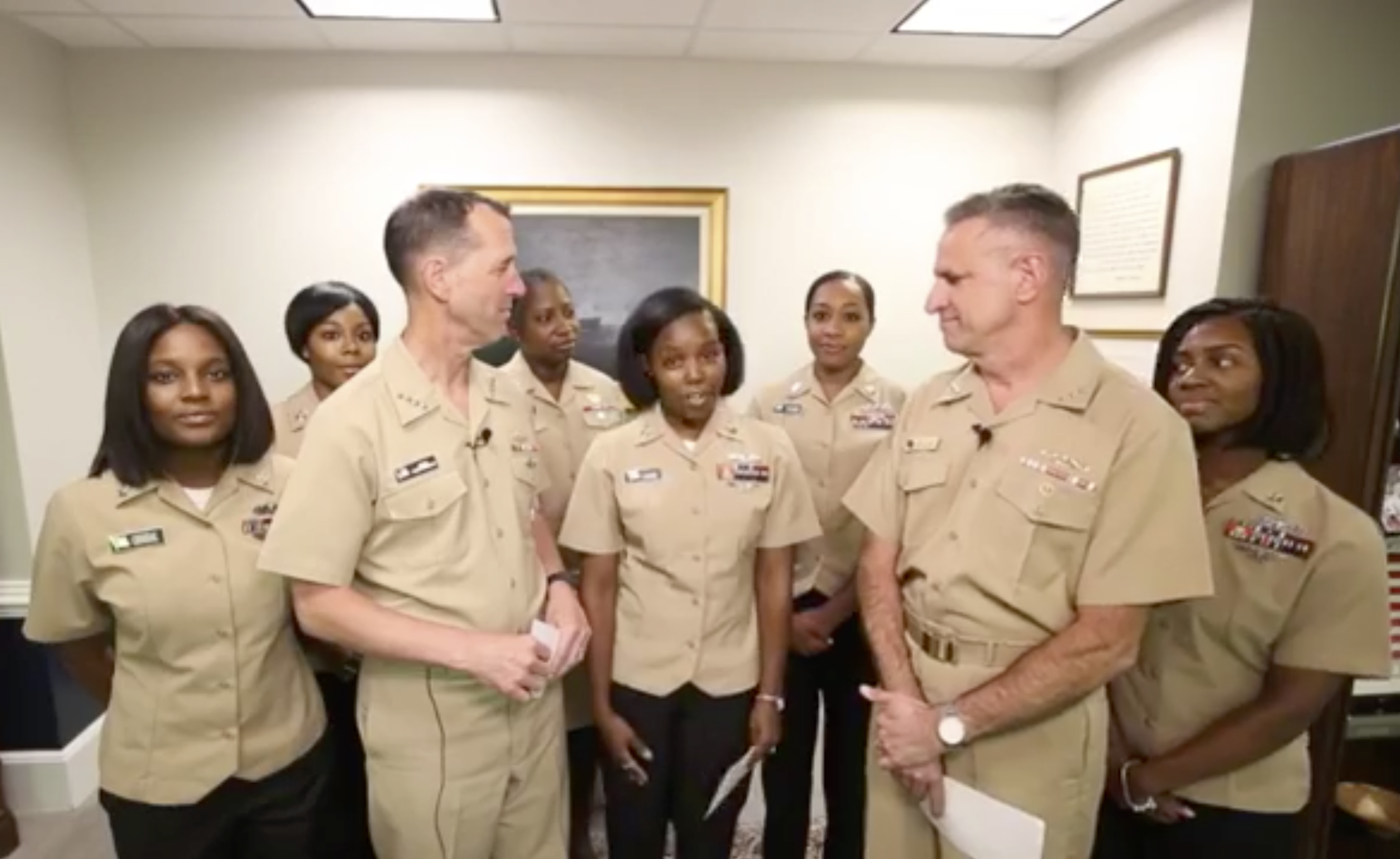 Yeoman First Class LaToya Jones, center, speaks as Chief of Naval Operations Adm. John Richardson, left of center, and Chief of Naval Personnel Adm. Robert Burke, right of center, and other members of a Navy working group. 
