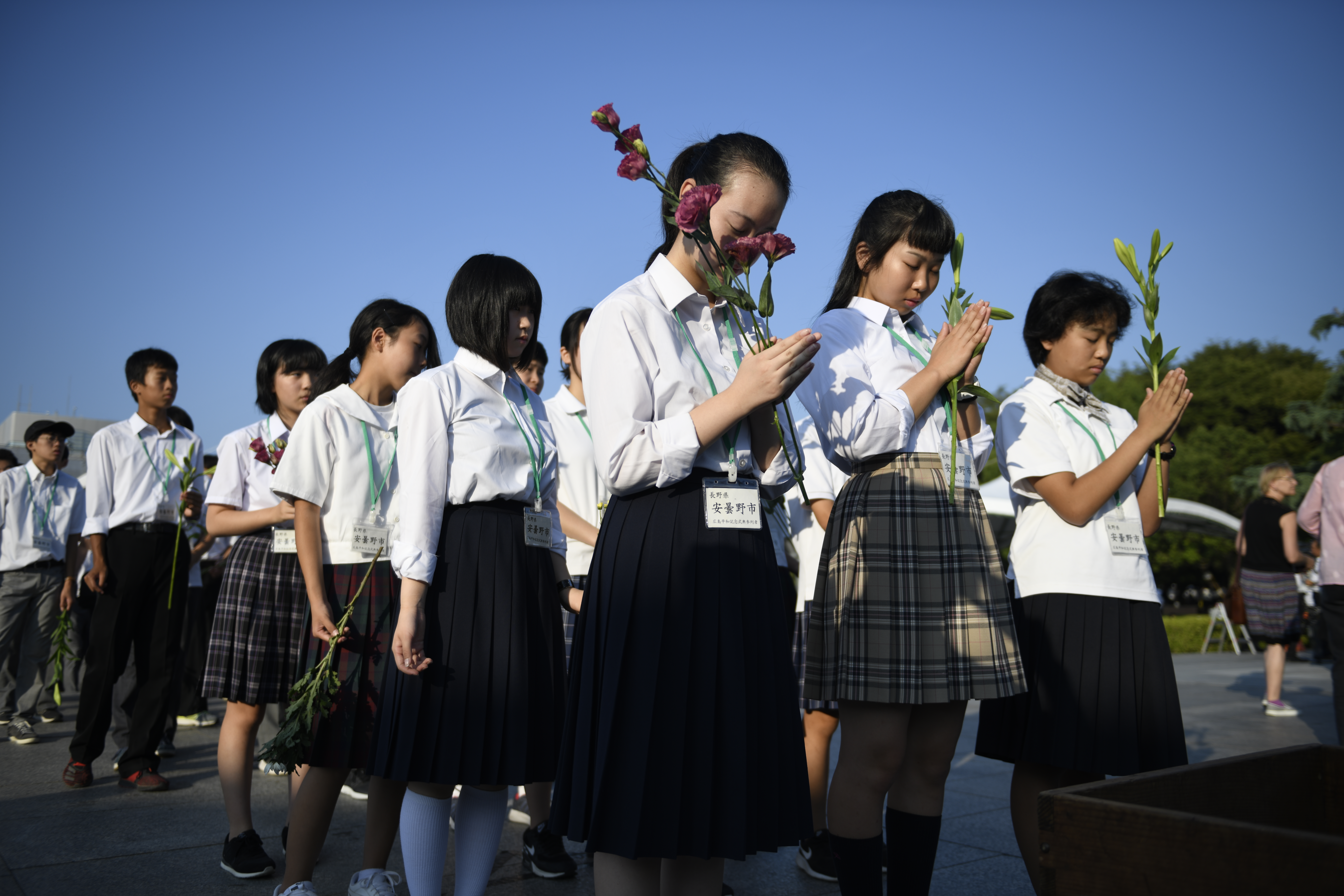 Visitors lays flowers and pray for the atomic bomb victims at the Hiroshima Peace Memorial Park in Hiroshima, August 6.