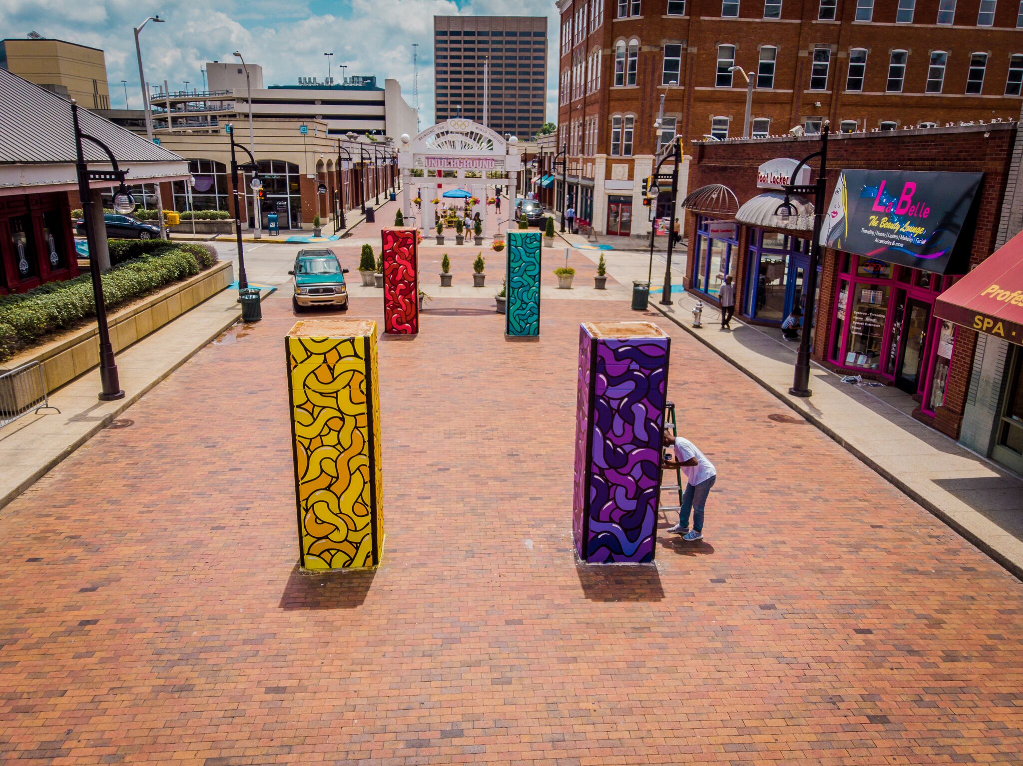Concrete pillars decorated with public art jut up from the street level at Underground Atlanta.