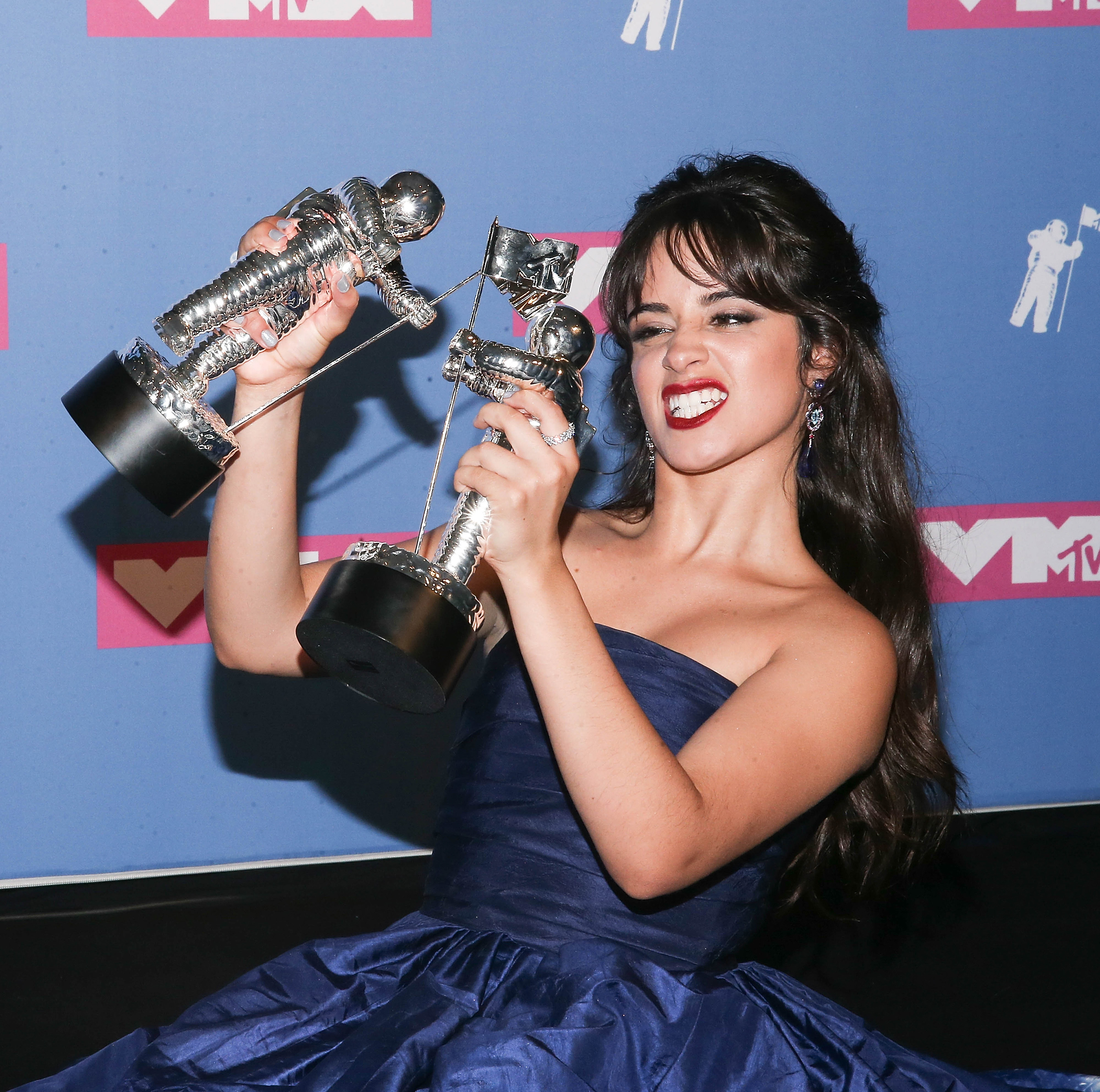 Camila Cabello holds her two Moon Person awards for Video of the Year and Artist of the Year at the 2018 VMAs.