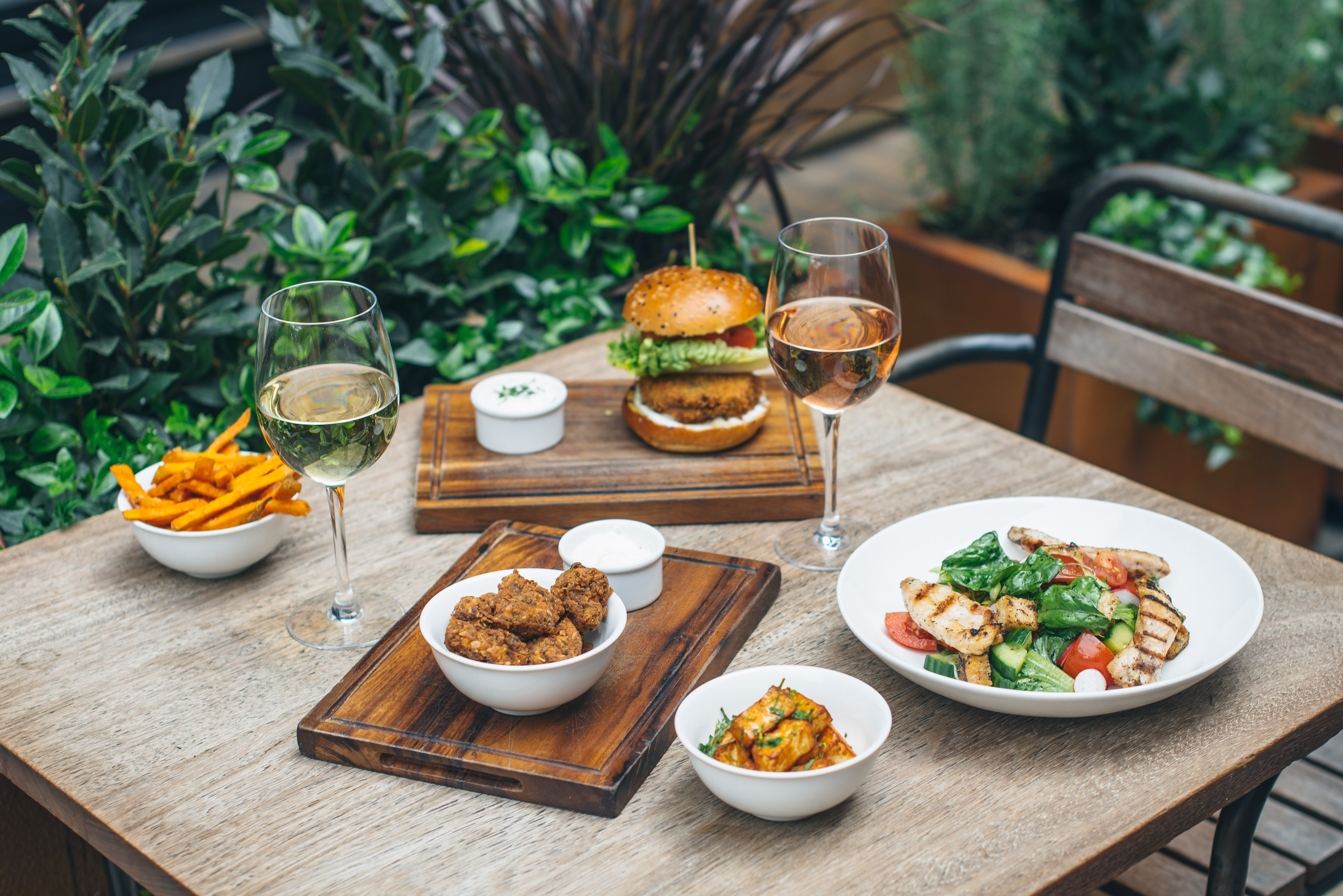 Free-range chicken burgers and salads with wine at Whyte and Brown, the free-range chicken restaurant in Kingly Court, Soho