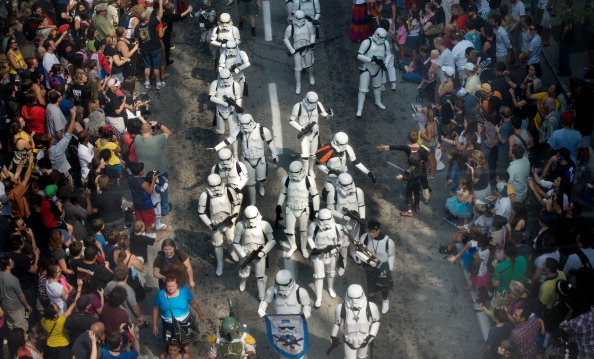 A photo of Star Wars stormtroopers in white marching down a street. 