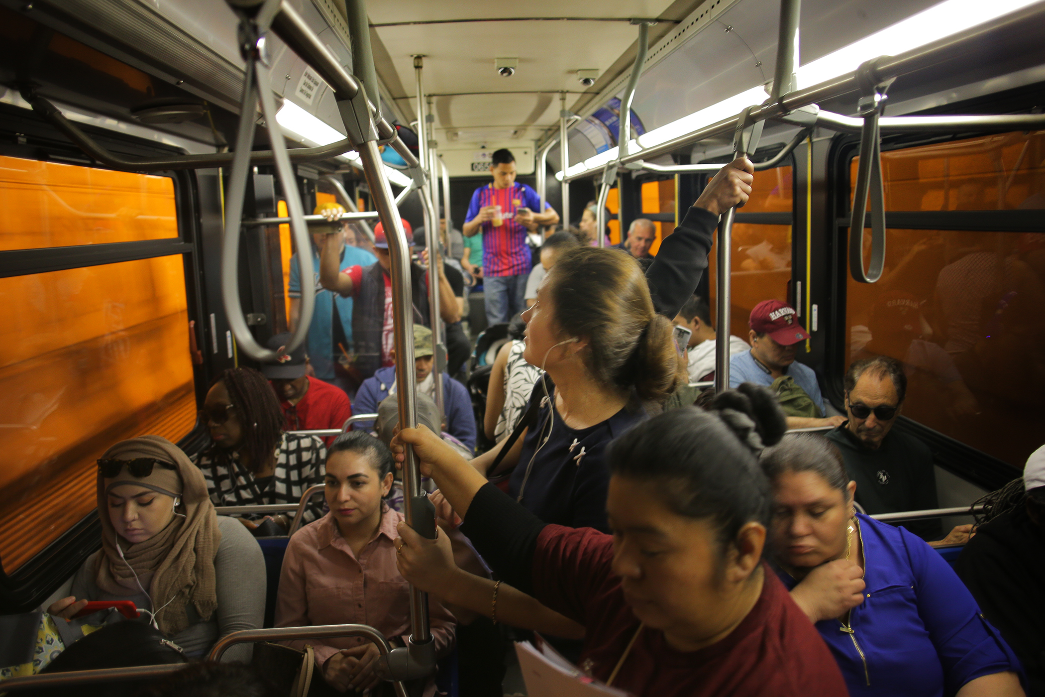 Riders on a crowded bus. 