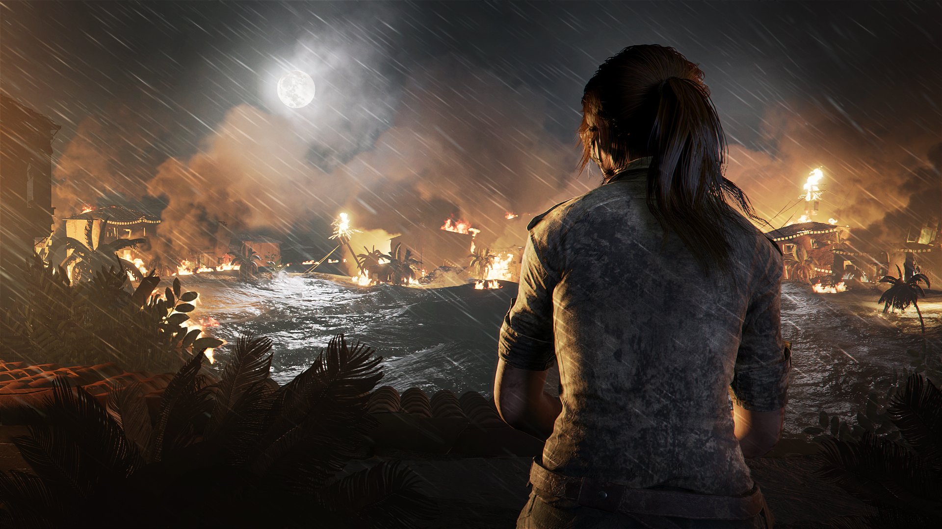 Shadow of the Tomb Raider - Lara sits looking at a burning village