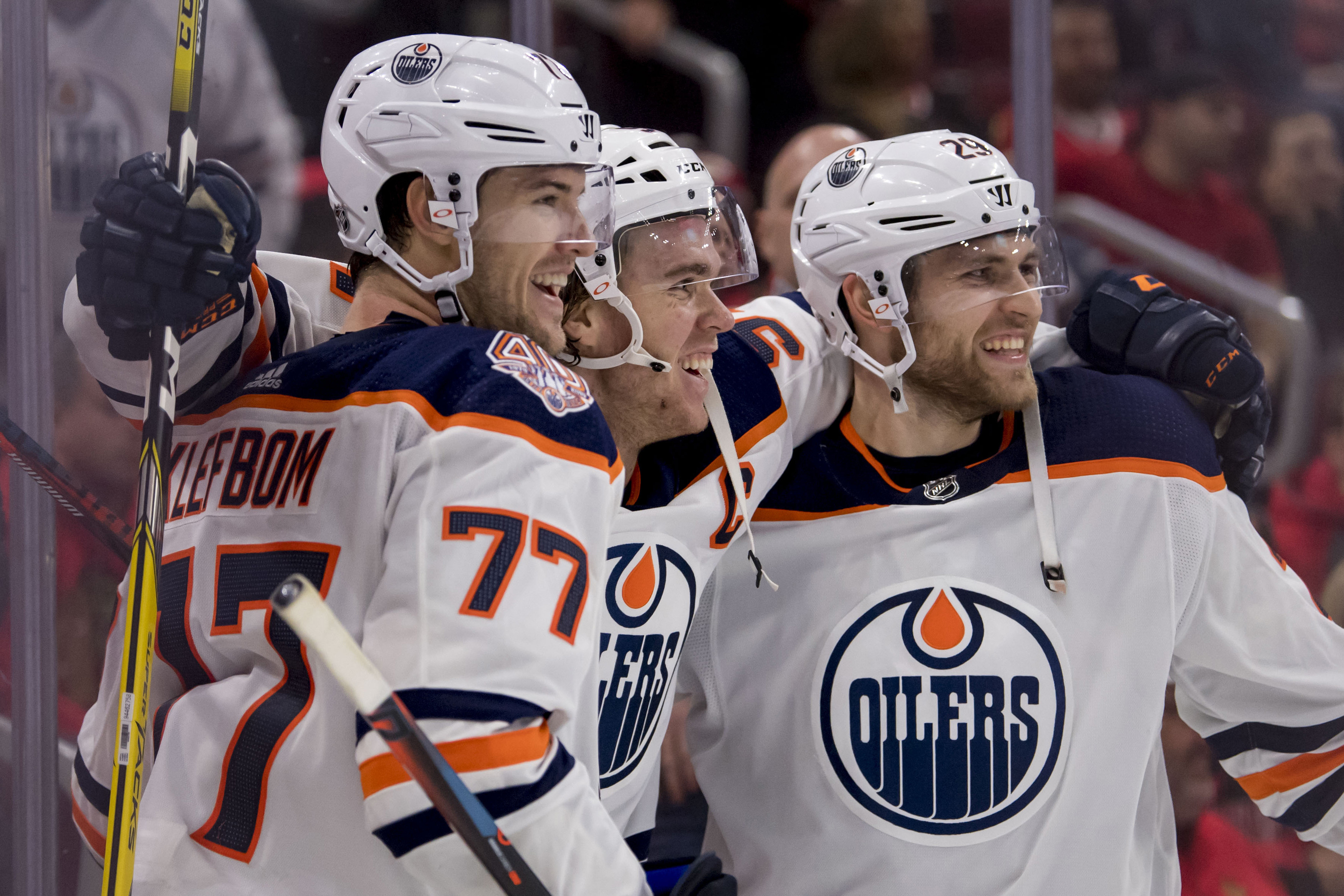 Oct 28, 2018; Chicago, IL, USA; Edmonton Oilers center Connor McDavid (center) celebrates his game winning overtime goal with center Leon Draisaitl (right) and defenseman Oscar Klefbom (left) during overtime against the Chicago Blackhawks at the United Ce