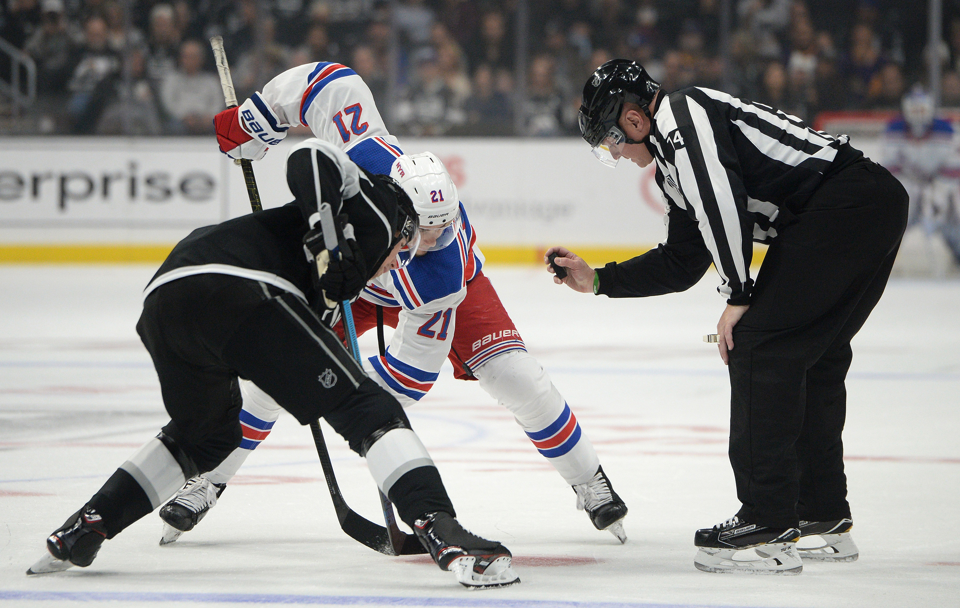 Oct 28, 2018; Los Angeles, CA, USA; New York Rangers center Brett Howden (21) and Los Angeles Kings center Adrian Kempe (left) await referee Dennis LaRue (14) during a face-off during the first period at Staples Center.&nbsp;