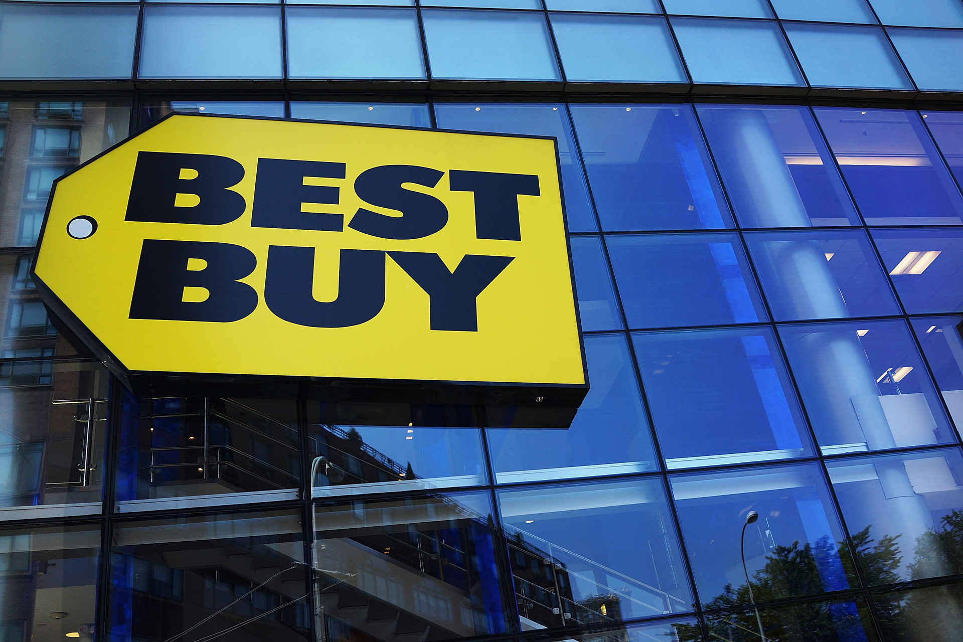 A photo of the Best Buy logo on a store