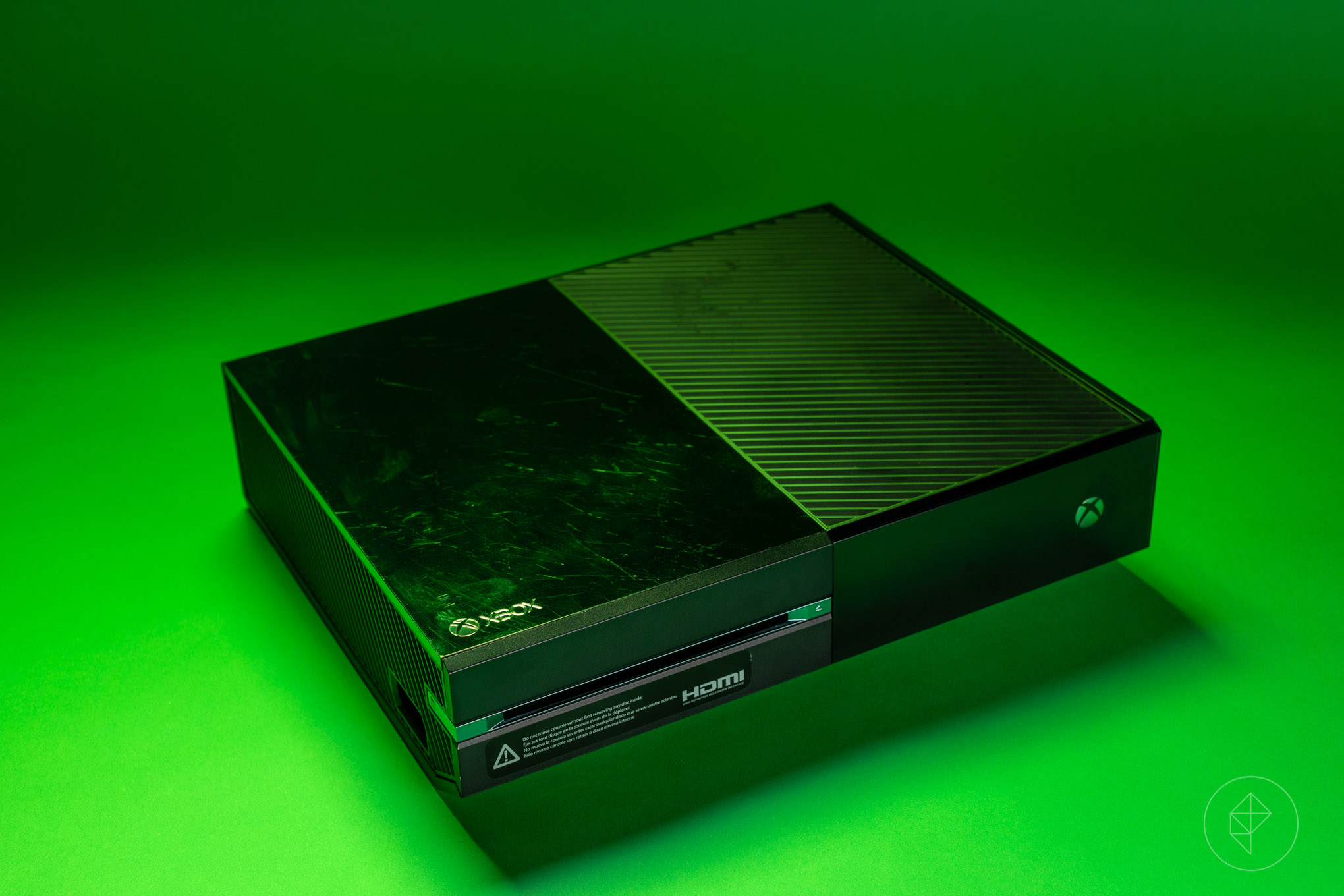 photo of Xbox One front left angle from above, on green background
