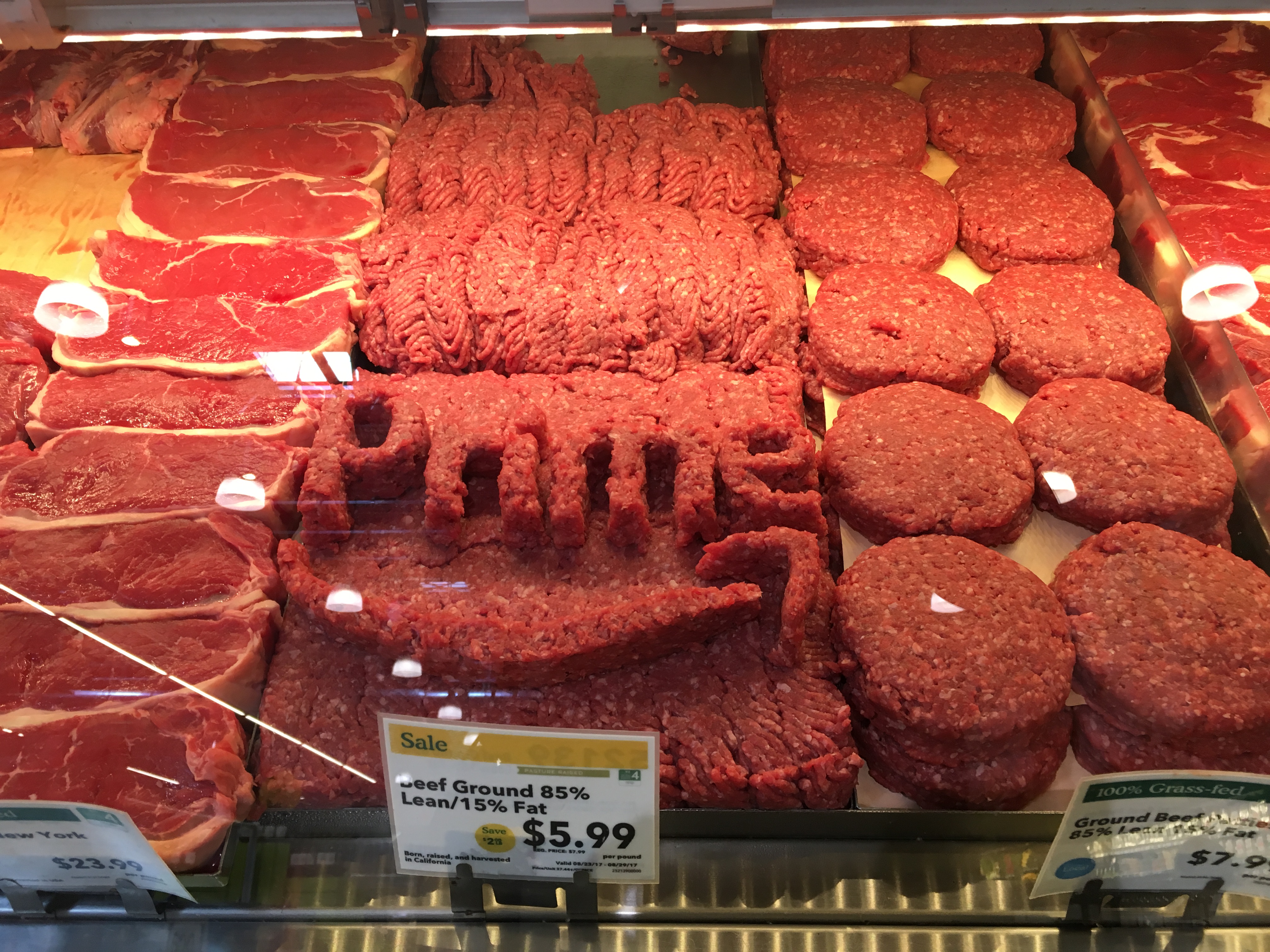 The Amazon Prime logo made out of chopped meat inside a Whole Foods store