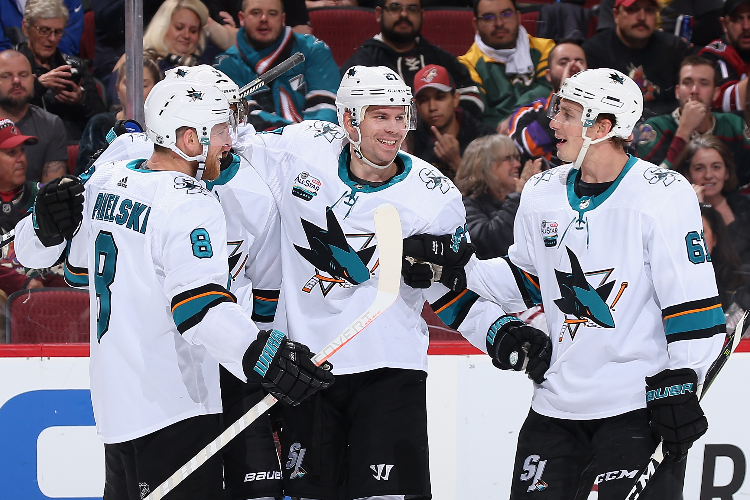 GLENDALE, ARIZONA - DECEMBER 08: (L-R) Joe Pavelski #8, Evander Kane #9, Joonas Donskoi #27 and Justin Braun #61 of the San Jose Sharks celebrate after Kane scored a goal against the Arizona Coyotes during the second period of the NHL game at Gila River A